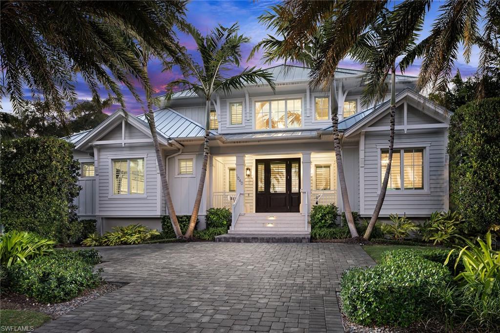Exceptional Old Florida-inspired residence built in 2020 by Griffin Builders and designed by MHK Architecture, just two blocks from the Gulf and near shopping and dining of 3rd St. S. and 5th Ave. S. Offered furnished, this six-bedroom, six full and two half-bath home showcases inviting coastal design throughout, with wide plank French oak floors, soaring ceilings, custom millwork and designer lighting. A glass-enclosed wine room opens to the great room, anchored by an elegant fireplace and flowing seamlessly into the show-stopping chef’s kitchen with dual islands, 60-inch Wolf range, dual Sub-Zero refrigerators, dual dishwashers, built-in coffee maker, dual sinks and premium fixtures. The light-filled Florida room with an outdoor kitchen opens to a backyard oasis with resort-style pool, spa, deck jets, AstroTurf, lush landscaping and a pool bath. The first floor includes the primary suite with spa-inspired bath and walk-in closet, plus an additional en-suite bedroom. Upstairs, accessible via private elevator or staircase, a versatile loft with wet bar and Pecky Cypress accents is surrounded by four en-suite bedrooms, ideal for entertaining, media or casual living. Additional features include a temperature-controlled garage, impact-resistant glass and 22-kilowatt generator. A rare opportunity to enjoy refined Old Naples living within a short distance of the Gulf and the city’s finest shopping and dining.