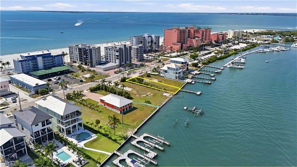 Premier Bayfront Homesite | High-Performance Vacation Rental Opportunity

Exceptional opportunity to build a luxury income-producing vacation rental property on this prime bayfront homesite overlooking Estero Bay, ideally located on the highly desirable north end of Fort Myers Beach. This rare 8,525± sq ft lot (50’ x 160’) offers the potential to design an elevated luxury residence with panoramic bay views and Gulf views just across the street, creating the ultimate beach-to-bay rental destination.

Perfectly positioned for the vacation market, this property offers direct boating access to Estero Bay and the Gulf of Mexico, with boating routes to Sanibel, Boca Grande, Cabbage Key, and numerous waterfront restaurants throughout Southwest Florida. The location is highly attractive to vacation guests seeking boating, beach access, and walkable island entertainment.

Design a large luxury rental residence featuring multiple bedrooms, expansive outdoor living areas, rooftop or balcony viewing decks, and a resort-style pool and spa overlooking the bay. The lot offers space for outdoor entertainment areas, a private dock, and sunset-view terraces—features that significantly increase rental demand and nightly rates.

An assemblage opportunity is also available with the adjacent lot at 385 Estero, creating potential for an even larger luxury rental compound or estate-sized development.

Just a short walk along the beach to Times Square, the Pier District, Margaritaville, and dozens of restaurants, shops, and entertainment venues, this location consistently attracts visitors seeking the best of Fort Myers Beach.

A rare investment opportunity to develop a premier waterfront vacation rental property in one of the island’s most desirable and walkable locations. Multiple Builder introductions available.