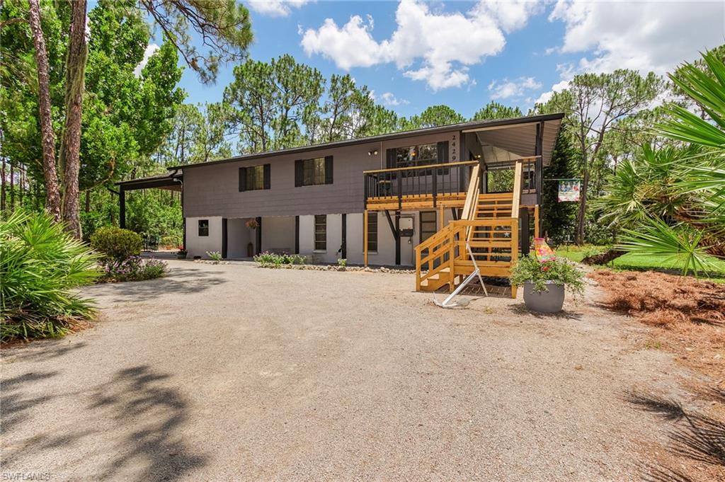 If you are looking for privacy and a tranquil setting beautiful San Carlos Estates in Bonita Springs has it all. This 1.25 acre home built in 1988 has 3 bedrooms and 2 baths on the upper level accessible by a newly built staircase.  The lower level is a large efficiency that could be a guest suite or rental apartment.  This 2 story home has FPL Solar on the roof which cuts the electric bill significantly.   There is a screened porch off the spacious master bedroom and off of the lower level living room.   There is plenty of storage OR work shop and a garage plus park your boat or RV (RV hookup with electric and water) under the extended side roof.  If you want chickens this area is zoned AG 2.  There are so many things about this spacious and tidy home you'll have to see for your self.  Cash only.
