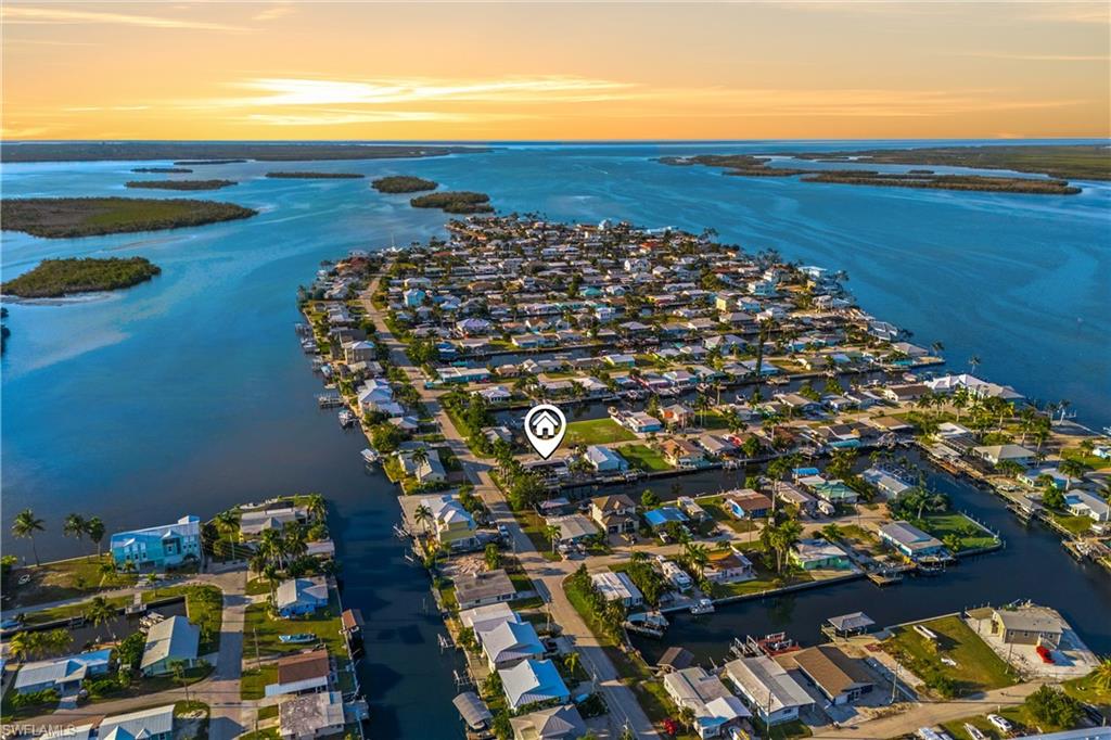 Welcome to 2631 Bayshore Drive, a classic Matlacha cottage that perfectly blends Old-Florida charm with the waterfront lifestyle this island is famous for. This beautifully maintained home offers three bedrooms, two bathrooms, and an inviting, open layout filled with natural light. The living room features a cozy fireplace, creating a warm focal point for gatherings. The kitchen and bathrooms have been thoughtfully updated, combining modern functionality with coastal style, while the home’s warm character and classic touches create a relaxing environment that instantly feels like home. Situated on a generous lot, the property offers an exceptional waterfront setup complete with a private boat dock and lift. From your backyard, you can step onto your boat and be cruising through Matlacha Pass within minutes, with direct access to the Gulf just pure boating convenience. Whether you enjoy fishing, island-hopping, or sunset cruises, this location is ideal for making the most of Southwest Florida’s world-class waters. A detached 1-car garage provides valuable storage and flexibility for island living, complementing the home’s effortless blend of charm and practicality. Living on Bayshore Drive places you right in the heart of one of Florida’s most colorful communities. You’re just a short walk or drive from Matlacha’s vibrant art galleries, quaint shops, waterfront restaurants, and beloved local attractions. The neighborhood offers a laid-back, welcoming atmosphere that captures the true spirit of island life.
