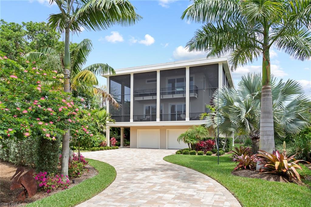 No Renovations Needed! Just Bring Your Swimsuit . . Simply The Best! Beautifully designed 4BR/4BA custom home on West Gulf Drive across from the beach access. This home sits on a lot that is over an acre and was completed in 2019. This spacious homebuilt for entertaining and the Sanibel lifestyle includes a wrap around screened porch, accessible from every room in the home through 8' sliders. Spacious great room with gas fireplace, 10’ ceilings and a glassed elevator to the third floor master suite and guest room areas. Gourmet kitchen with gas cook top, double ovens, Cambria Quartz counters, wine cooler and stainless appliances. Oversized salt water pool and native vegetation. Gulf views. Full house generator, all impact glass with white oak flooring throughout. Oversized garage, paver driveway and landscape lighting.