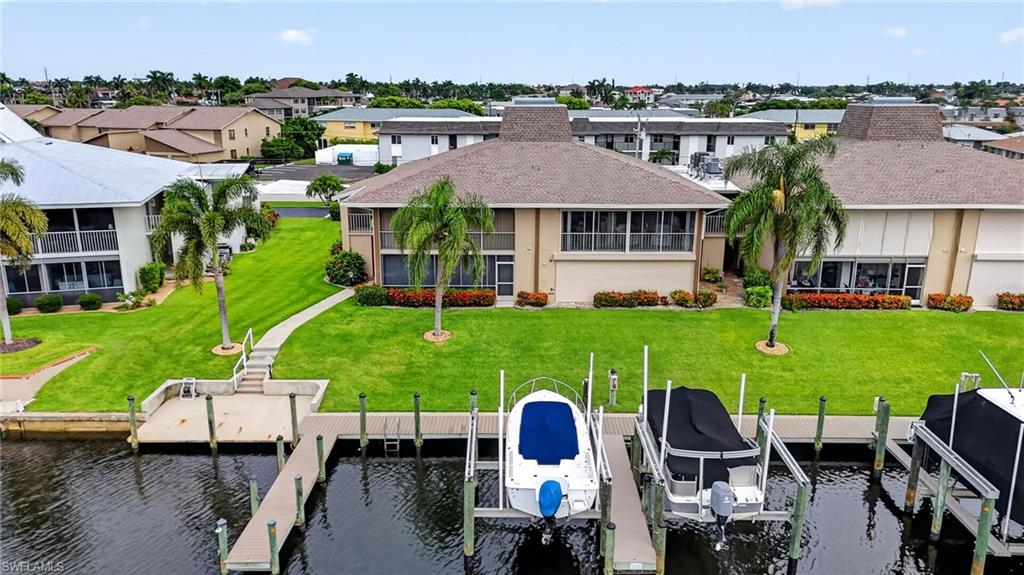 THE "SALT-LIFE" BOATING-FISHING-SUNSHINE-BEACHES! INCREDIBLE WATERFRONT VALUE NEAR THE BRAND NEW JAYCEE PARK  – UNDER 5 MINUTES TO THE CALOOSAHATCHEE River RIGHT FROM YOUR OWN BOAT LIFT - NO BRIDGES.  Located in a desirable 55+ waterfront community, this beautifully maintained home offers the perfect blend of comfort, convenience, and Florida living. The bright white kitchen features a new refrigerator, a breakfast bar with seating for two, a large pantry, and white Corian countertops. The spacious floor plan includes three large bedrooms, two full bathrooms, tile flooring throughout the main living areas, and warm carpeting in two of the bedrooms. Two fireplaces add warmth and ambiance, creating inviting spaces to relax.  The enclosed lanai provides the perfect setting for entertaining or simply ENJOYING PEACEFUL WATER VIEWS YEAR-ROUND. Boaters will enjoy your own 8,000-pound boat lift with new composite decking, offering easy access to the water.  Most of the furniture will remain with the home, making your move even easier. Best of all, the HOA covers all exterior maintenance, allowing you to enjoy a low-maintenance lifestyle. With Cape Coral's best dining, shopping, and entertainment just minutes away, this home truly offers affordable waterfront living at its finest. You really can have it all!  THIS HOME COMES WITH A ONE YEAR COMPLETE HOME WARRANTY FOR TOTAL BUYER COMFORT.