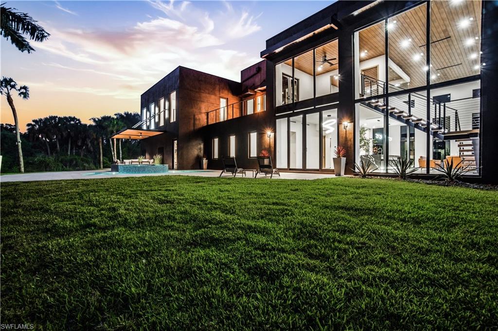 This isn’t coastal soft.
This is steel, concrete, wood, and glass. Volume. Texture. Intention.

This is not merely a house — it is the destination.

A triumph of design, craftsmanship, and architectural audacity, 27100 Imperial Parkway is a nearly 5,000-square-foot residence under air (over 7,000 total!) set on a private acre of natural preserve. Completed in 2026, this one-of-a-kind modern sanctuary fuses precision engineering with warm livability — bold yet refined, dramatic yet deeply intentional.

Imagine total privacy, buffered by nature, while remaining moments from world-class coastal dining, shopping, and entertainment. Secluded — but never disconnected. Upon arrival, a grand entrance with soaring 22-foot ceilings immediately establishes the scale. Natural light pours through expansive walls of glass, illuminating sculptural interiors defined by clean lines and curated materials. Two floating staircases — each step individually LED-illuminated — function as architectural art. Exposed steel beams add industrial edge, softened by warm woods and bespoke finishes. Designed for elevated entertaining, the chef’s kitchen features top-tier Viking appliances, custom cabinetry, and statement fixtures. A separate guest suite or executive office with it's own private entrance, private bath and sleek wet bar offers flexibility without compromise. Luxury is found in the details: solid-core doors, a designer lighting package, custom built-ins with integrated LED accents, and even a discreet laundry chute from the primary suite. Every element has been considered.

Then the walls disappear.

An entire expanse of glass opens to a private outdoor oasis where stone decking surrounds a striking pool and expansive covered terrace. The preserve beyond becomes living artwork — tranquil, protected, and ever-changing. Above it all, a rooftop deck offers the ultimate vantage point for sunset cocktails and stargazing.

Built with enduring quality, including all impact glass throughout, this residence is as structurally impressive as it is visually stunning.

For the automotive enthusiast, the property is nothing short of extraordinary. A massive driveway, elegant stainless steel water sculpture, and an enormous garage designed to astonish — featuring towering impact-glass doors and ceilings with unique hexagon LED lighting, designed to accommodate lifts, allowing the five-car garage to hold up to ten vehicles. Boaters and RV owners will find ample parking as well. 

Located just about a mile from Imperial 41 and Sugar Shack and a short drive to downtown Bonita, this architectural masterpiece offers rare proximity to convenience while preserving complete privacy.

Agent-accompanied showings by appointment only.
Experience a residence where design is deliberate, luxury is effortless, and living is elevated.