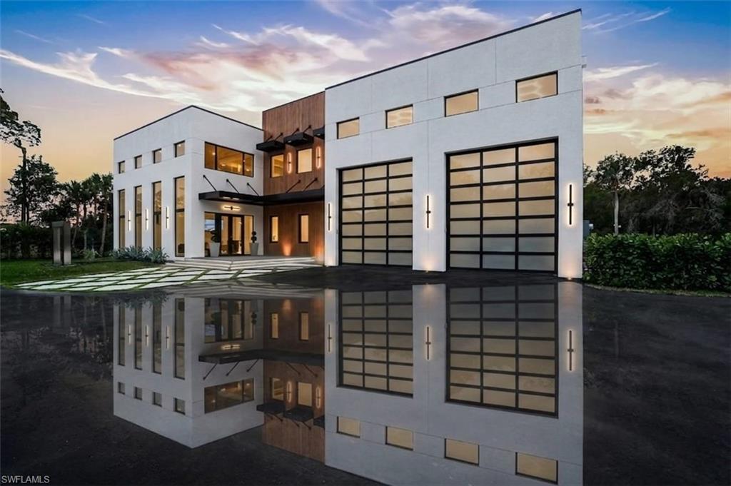 This isn’t coastal soft.
This is steel, concrete, wood, and glass. Volume. Texture. Intention.

This is not merely a house — it is the destination.

A triumph of design, craftsmanship, and architectural audacity, 27100 Imperial Parkway is a nearly 5,000-square-foot residence under air (over 7,000 total!) set on a private acre of natural preserve. Completed in 2026, this one-of-a-kind modern sanctuary fuses precision engineering with warm livability — bold yet refined, dramatic yet deeply intentional.

Imagine total privacy, buffered by nature, while remaining moments from world-class coastal dining, shopping, and entertainment. Secluded — but never disconnected. Upon arrival, a grand entrance with soaring 22-foot ceilings immediately establishes the scale. Natural light pours through expansive walls of glass, illuminating sculptural interiors defined by clean lines and curated materials. Two floating staircases — each step individually LED-illuminated — function as architectural art. Exposed steel beams add industrial edge, softened by warm woods and bespoke finishes. Designed for elevated entertaining, the chef’s kitchen features top-tier Viking appliances, custom cabinetry, and statement fixtures. A separate guest suite or executive office with it's own private entrance, private bath and sleek wet bar offers flexibility without compromise. Luxury is found in the details: solid-core doors, a designer lighting package, custom built-ins with integrated LED accents, and even a discreet laundry chute from the primary suite. Every element has been considered.

Then the walls disappear.

An entire expanse of glass opens to a private outdoor oasis where stone decking surrounds a striking pool and expansive covered terrace. The preserve beyond becomes living artwork — tranquil, protected, and ever-changing. Above it all, a rooftop deck offers the ultimate vantage point for sunset cocktails and stargazing.

Built with enduring quality, including all impact glass throughout, this residence is as structurally impressive as it is visually stunning.

For the automotive enthusiast, the property is nothing short of extraordinary. A massive driveway, elegant stainless steel water sculpture, and an enormous garage designed to astonish — featuring towering impact-glass doors and ceilings with unique hexagon LED lighting, designed to accommodate lifts, allowing the five-car garage to hold up to ten vehicles. Boaters and RV owners will find ample parking as well. 

Located just about a mile from Imperial 41 and Sugar Shack and a short drive to downtown Bonita, this architectural masterpiece offers rare proximity to convenience while preserving complete privacy.

Agent-accompanied showings by appointment only.
Experience a residence where design is deliberate, luxury is effortless, and living is elevated.