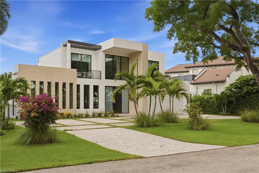 Enjoy your vacation in one of Naples’ most desirable locations! Nestled in a beautiful, quiet neighborhood in Olde Naples, this stunning contemporary home is just blocks from the pristine Gulf beaches and a short bike ride to the shops and restaurants of Fifth Avenue South and Third Street South. This spacious 4-bedroom, 4.5-bath residence welcomes you with an open-concept floor plan, elegant artwork, comfortable furnishings, and abundant natural light. The living room features a large flatscreen TV and opens seamlessly to the outdoor lanai and pool area, creating the perfect indoor-outdoor living experience. The gourmet kitchen is fully equipped with quartz countertops, quality appliances, ample storage, and bar seating for casual dining. Adjacent to the kitchen, the dining area comfortably seats eight guests and includes a convenient buffet for entertaining. For those who need to stay connected, a private office and high-speed internet are available throughout the home. The Primary Suite on the first floor has a King-size bed, large walk-in closet, blackout curtains, access to the lanai and pool, and enjoys a luxurious en-suite bath with dual sinks, and a spacious walk-in shower. The second floor has two guest bedrooms with queen-size beds, walk-in closets, and connecting baths featuring walk-in showers. A 3rd guest suite is a second primary-style suite with a king-size bed, large walk-in closet, outdoor sitting area, and private bath with dual sinks, and a spacious shower. The second-floor game room offers a pool table, bar seating, beverage refrigerator, access to the upper-level lanai. Step outside to enjoy the beautifully appointed outdoor living area, complete with a private heated pool, outdoor fireplace, outdoor kitchen with gas grill, dining table and seating for six, and comfortable lounge furniture and chaises for relaxing and entertaining. 
   Whether you spend your days at the pristine sandy beach, biking through Olde Naples, or enjoying the    area’s world-class shopping and dining, this exceptional house provides the perfect setting for an unforgettable Naples vacation.
