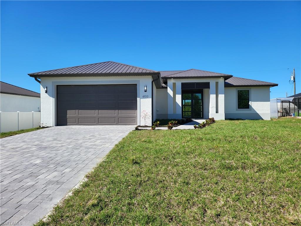Certificate of Occupancy completed and ready to move in now!! NEW CONSTRUCTION SINGLE FAMILY HOME WITH BUILDER WARRANTY ON A LARGE LOT WITH NO ASSOCIATION DUES! This home has a metal roof and impact windows & doors! Gorgeous contemporary layout w/ open concept kitchen, center island, quartz countertops, stainless steel appliances, split bedroom floor plan, luxury plank tile flooring throughout, contemporary double door front entry, large slider system in the rear of the home, laundry room w/ washer dryer hookups, multiple sets of tray ceilings, crown molding, walk-in closet, frameless shower door in master bath & huge shower niche with mosaic glass tile, paver driveway, walkway and patio with a 2-car garage. You will love this amazing home with top quality construction! The first set of pictures are of the actual home listed. The staged pictures can provide furniture ideas.