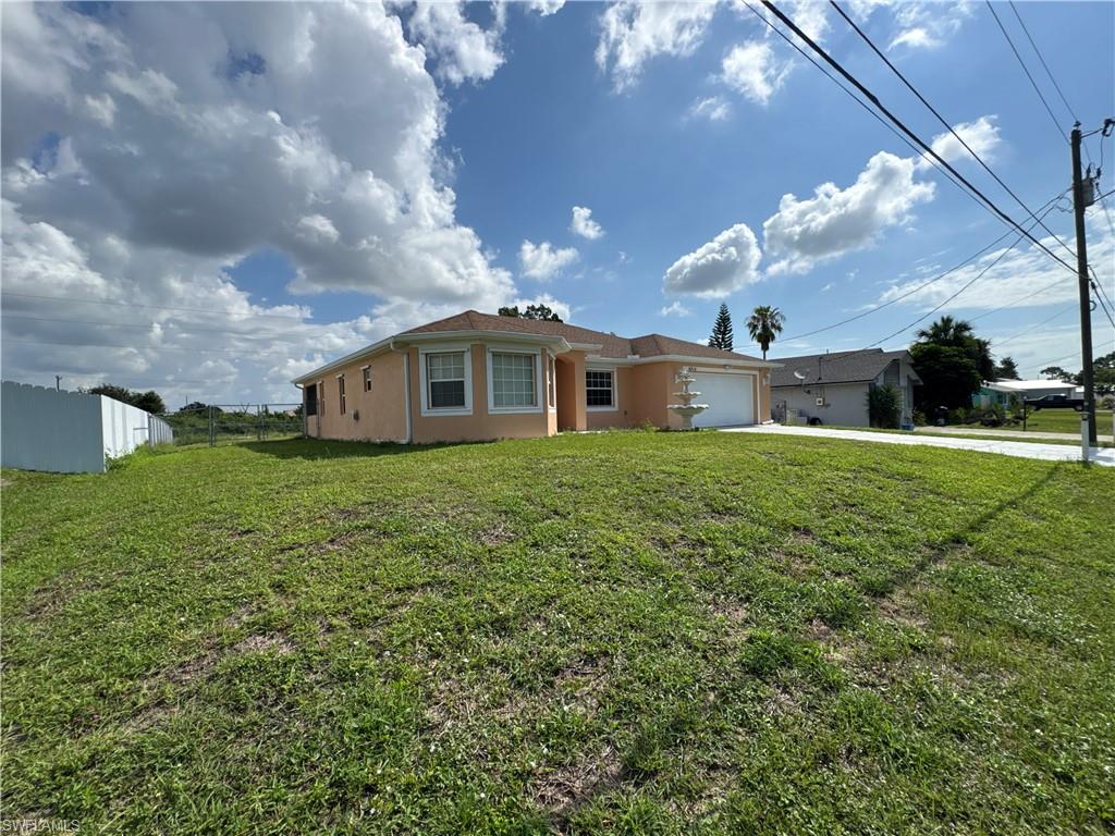 Beautiful rental home in a prime Lehigh Acres location, conveniently situated near Lee Blvd and State Road 82, providing easy access to shopping, dining, schools, and major commuting routes. Offering nearly 1,900 square feet of living area, this well-maintained residence features 3 bedrooms, 2 bathrooms, a living room, dining area, and family room. The kitchen is designed for both functionality and entertaining, featuring a center island, breakfast bar, ample cabinetry, and generous counter space. The laundry room, located inside the residence, includes built-in cabinets and a utility sink. The home also offers a 2-car garage. The primary suite features a tray ceiling, a walk-in closet, and an ensuite bathroom with dual vanities, a walk-in shower, and a separate soaking tub. Tile flooring runs throughout the entire home, including the screened lanai. The fully fenced backyard offers a spacious outdoor area with plenty of room for outdoor activities, entertaining, and enjoying the Florida lifestyle. Schedule your private showing today.