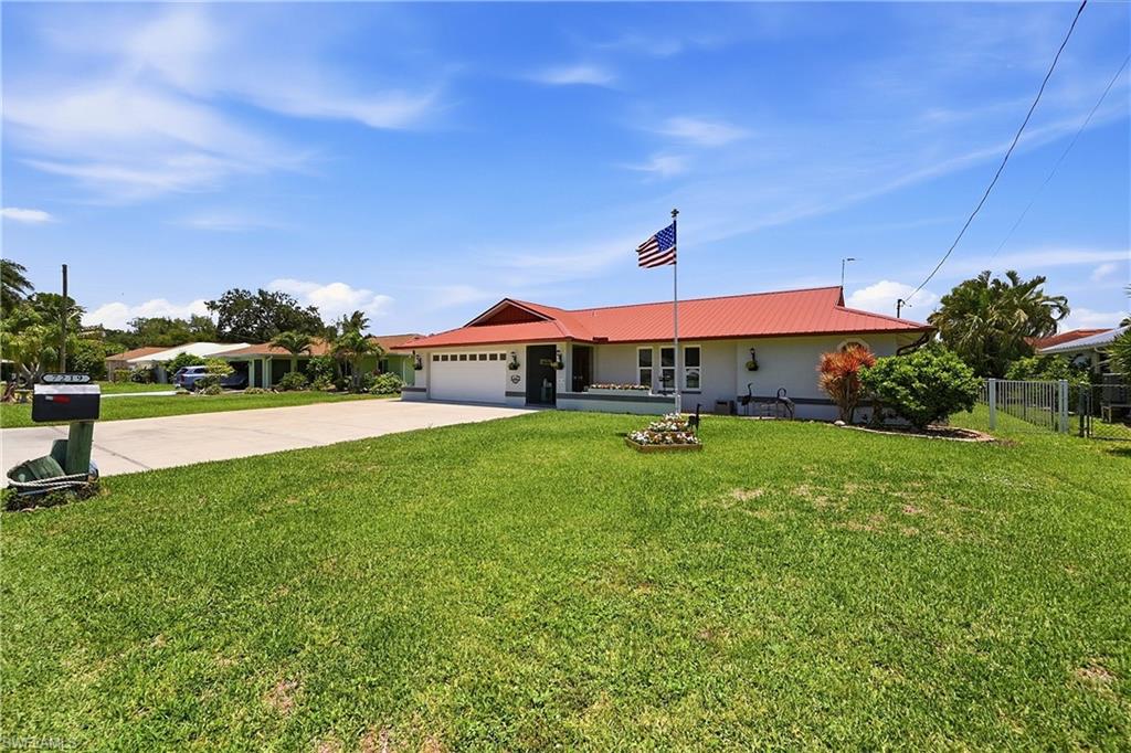 Move-in-ready, furnished home featuring two newly installed hurricane-proof sliding doors—one in the formal dining room and another in the breakfast nook. The split floor plan places the master suite on one side of the home and the remaining three bedrooms, second bathroom, and den on the oposite side. The layout features interior highlights such as the sunken living room complete with a fireplace and a vaulted ceiling in the familyroom (currently being used as an additional dining area). Ideal for both daily living and entertaining, the home centers around a kitchen that overlooks the lanai and the canal, where your private boat lift awaits. The kitchen is equipped with granite countertops, a ceramic sink, a stainless steel dishwasher, and double ovens. Recent exterior updates include a white metal fence enclosing the backyard, a newly screened and resurfaced lanai, and a walkway leading to the dock and an epoxy floor in the two car garage. The dock is equipped with a private fuel pump, and the boat lift holds      . Conveniently located just five houses from open water, the property offers quick boat access to local destinations, including a nearby tiki bar 15 minutes to the left, and Marine Town and downtown dining options just minutes to the right. The salt water pool has both solar heat and has an electric pool heater and the pool system is equipped with Wi-Fi connectivity. Also the property features a whole-house generator for uninterrupted power. A utility shed on the side of the home is equipped with electric and a concrete floor.