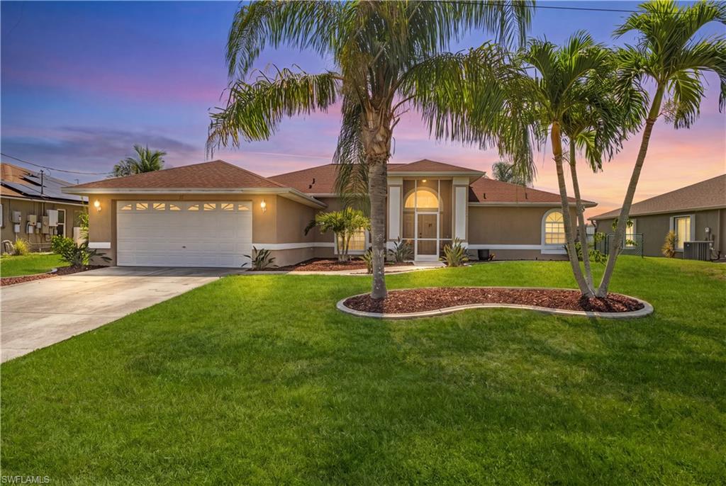 Welcome to this beautifully updated 4-bedroom plus den, 2.5-bath pool home offering over 2,460 square feet of thoughtfully designed living space. Featuring modern updates, generous indoor and outdoor living areas, and a functional split floor plan, this move-in-ready property offers exceptional comfort and style.
Step inside to soaring vaulted ceilings, abundant natural light, and an open-concept layout that creates a bright, spacious atmosphere throughout the home. The fully remodeled kitchen is a standout feature, showcasing quartz countertops, custom white shaker cabinetry, stainless steel appliances, designer hardware, an oversized center island, and a marble-inspired backsplash. The kitchen overlooks the main living and dining areas, creating a seamless flow for everyday living and entertaining.
The spacious primary suite includes 2 walk-in closet and an ensuite bathroom with dual vanities, a soaking tub, and a separate walk-in shower. Three additional bedrooms, along with a versatile den, provide flexible space that can be used as a home office, media room, hobby room, fitness area, or additional workspace.
A beautifully renovated guest bathroom features floor-to-ceiling designer tile, brushed gold fixtures, updated lighting, and contemporary finishes that complement the home's modern design.
Sliding glass doors open to the screened lanai and private pool, offering an inviting outdoor living space with room for dining, relaxing, and entertaining. The concrete dock overlooks the lake, providing a scenic waterfront setting and an ideal place to enjoy the outdoors.
Additional features include luxury vinyl plank flooring throughout the main living areas, updated finishes, an indoor laundry room, an attached two-car garage, mature tropical landscaping, and a spacious .23-acre lot.
Conveniently located near shopping, dining, golf courses, parks, medical facilities, and everyday amenities, this well-maintained Cape Coral home offers a combination of modern upgrades, flexible living space, and an attractive waterfront setting.
Schedule your private showing today to experience everything this beautifully updated Cape Coral pool home has to offer.