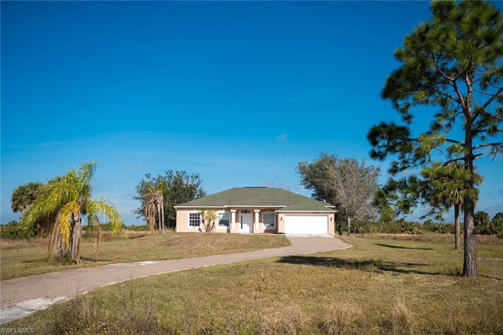 Spacious well maintained home in Golden Gate Estates. This home will provide you with privacy and the space for the perfect Florida lifestyle. At 2100 sq. feet, you will have  plenty of space for entertainment and storage. This 3 bedroom 2 bath home features an open floor plan, indoor laundry room, costume crown molding and a lovely paved driveway. Owner also owns empty lot next door, and is interested in selling as well. Look no further and make this ranch style home yours today!