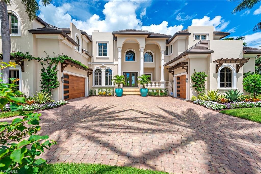 One or more photo(s) has been virtually staged, AI generated or rendered.  Tucked away in one of Naples’ most prestigious waterfront neighborhoods, this masterfully designed residence is a sanctuary of elegance, comfort, and mindful living. Set on a prized T-lot with expansive canal views, the home offers exceptional privacy, easy boating access, and the rare ability to accommodate a large vessel with ease.

Inside, a refined blend of traditional design and modern luxury creates a warm, welcoming atmosphere. With six spacious bedrooms—each with its own private ensuite—the home effortlessly balances everyday functionality with elevated style. A separate guest suite with its own entrance, kitchenette, and laundry facilities offers exceptional flexibility for visitors or extended family.

Soaring ceilings and thoughtfully curated architectural details define the interior, from the grand arched passages to the custom millwork and serene color palette. A dedicated meditation space and the home's northern rear orientation invite harmony and wellbeing, creating a peaceful retreat inspired by principles of balanced design.

The home also includes two half-baths, a pool bath, and an elevator for convenience. A handsome study with panoramic water views provides a perfect work-from-home setting, while a temperature-controlled wine room offers the ideal environment to store and showcase a curated collection.

Engineered for healthy living, the property is equipped with a state-of-the-art three-tank whole-house reverse osmosis system that delivers high-quality, purified water throughout. Lush landscaping, private terraces, and an outdoor setting reminiscent of a Mediterranean villa make this home feel like a world away—yet it’s just moments from the beach, upscale shopping, and top-tier dining.

Whether you're searching for a luxurious year-round home or a remarkable seasonal getaway, this exceptional property offers the perfect combination of location, lifestyle, and long-term value in the heart of coastal Naples.