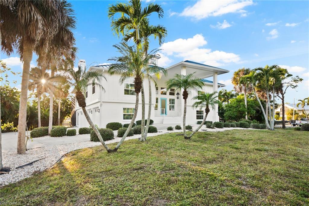 Situated in the serene heart of Bokeelia, this exquisite lakefront property offers a perfect blend of luxury and nature, where privacy meets beauty. Imagine waking up to a panoramic nature view, greeted by mature trees and a chorus of wildlife. Spend your mornings exploring nature walking paths, or enjoy bird watching by pristine lakes. Recently renovated with a new metal roof in 2022, this generously sized 3 Ensuite bedroom home boasts all impact windows and sliding doors, ensuring peace of mind and energy efficiency. An elevator provides effortless access throughout the home, while new fixtures and fans add a touch of modern elegance. The spacious kitchen shines with all stainless appliances, a Large breakfast bar, and an open concept to the living area, great for entertaining! The formal dining room doubles as a game room with a billard table that converts to a beautiful dining table! Step outside to a gorgeous pool adorned with pouring fountains, encased by a two-story reinforced screened enclosure, perfect for year-round enjoyment. It's plumbed for an outdoor kitchen, setting the stage for delightful gatherings. Snuggle by the cozy fireplace indoors or venture out to renowned local attractions such as the famous Tarpon Lodge Restaurant, Randall Research Center and the Calusa Indian Archeological Site. With proximity to marinas, shopping, and diverse dining venues, this property embraces both adventure and tranquil living, a true haven for those seeking a picturesque lifestyle.This property would be the perfect home for a large family or is currently being used as a second home and investment property with rentals in place!!