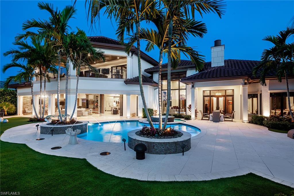 Experience complete luxury in this beautifully appointed estate home at Talis Park. Enjoy outdoor living at its best, complete with custom pool and spa, outdoor kitchen and granite-topped bar, built-in fireplace, and a stunning view of the 14th fairway. This home has been completely remodeled with endless upgrades including under-lit Cristello countertops in the chef's kitchen and wet bar, shell stone flooring with custom wood inlays, and stunning wall and ceiling details. The master retreat features a deluxe walk-in shower with multiple shower heads, a free-standing soaking tub, separate water closets and two vanities. Each guest room offers a deluxe, private en-suite. Use the elevator or take the stairs up to the second floor where you will find the ultimate entertaining space and private VIP guest suite. The upstairs balcony showcases expansive views in all directions. Talis Park is one of the most exclusive residential golf communities in Southwest Florida. Take in the cutting-edge fitness center, spa, and resort-style pool featuring a bar overlooking Talis Park's Greg Norman and Pete Dye-designed golf course.