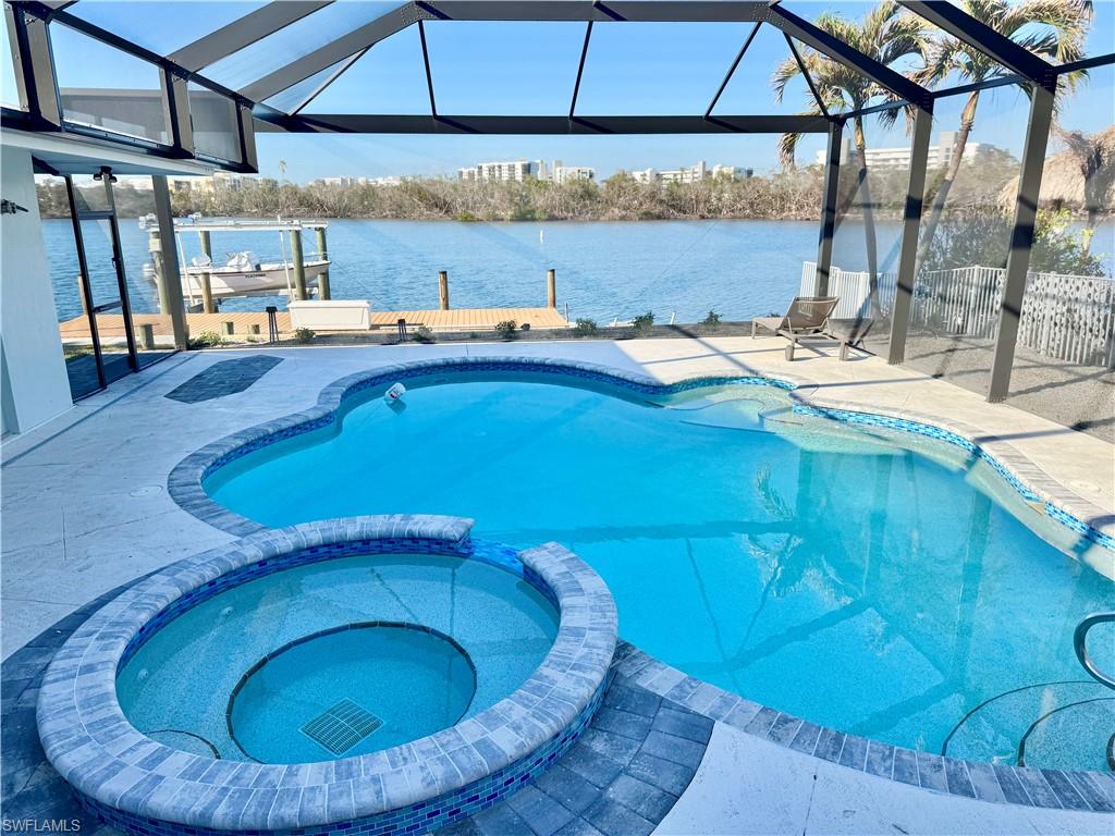 Breathtaking view over looking the pool and out to the Lagoon. Peaceful & tranquil on this oversized lot, almost 1/4 acre! Deep water and only a short boat ride or walk to the Gulf. Large free form pool with all new equipment and panoramic screened views out to the Bay. You will love entertaining around this pool especially sitting at the upper patio to be able to watch the dolphins and manatees swim by. This home offers 2200 sq ft of living space plus a Cabana room off of the pool that can be a fun gathering place, a pool bar or a 4th bedroom guest suite with it's own half bath. The property has a grandfathered 40 ft boat dock with lift and deep quick gulf access. The dock can accommodate pretty much any size boat with only minutes to the Bay & Gulf. This is prime waterfront property! The home has been completely updated in 2023. Metal roof was installed in 2021. The Great Room offers a beautiful updated kitchen with a huge granite Island, room for a formal dining area and living room underneath a gorgeous wood vaulted ceiling. Three good size bedrooms with 2 baths with large showers. Laundry room off the bedrooms with another access to the pool. House has been painted inside and out with fresh landscaping and a amazing circular paver driveway with plenty of room for parking. Laguna Shores is located at the South end of the Island and is a wonderful quiet neighborhood with 2 deeded beach access. Easy access off the Island to Lover's Key State Park, Bonita Springs and Naples. This beautiful home offers a true Florida life style! Being sold Furnished turnkey! Seller financing possible, will agreeable terms.