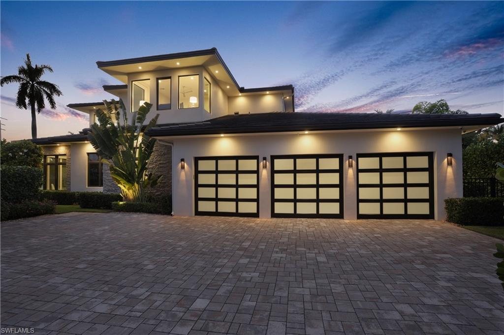 Newly completed, this home sets a new standard for architectural excellence in Naples. As you enter through the massive mahogany front door, you’re met with a soaring 25-foot ceiling, two elegant chandeliers, and the crisp meandering lines of the staircase as it makes its way to the second level. Expertly arranged by the world renowned Shawn Kronen Design Company, this home’s interior successfully merges warmth and livability with the beauty of a modern design. Just off the great room is a well-appointed master suite with a crystal chandelier, his and hers fitted out closets, a sitting nook, and a master bathroom that includes: a stand-alone bathtub, over-sized shower with rain shower-head, his and hers Toto toilets, variable colored cove lighting, and walls that shimmer from the meticulously applied layers of Venetian plaster. Just off the back of the house is an outdoor space equipped with an outdoor living room and fireplace, a Chef’s summer kitchen and dining area, a resort style pool and spa with a sun island, and electric roll down screens and storm shutters. A perfect space for leveraging Naples’ tropical climate into years of enjoyment for your family and friends.