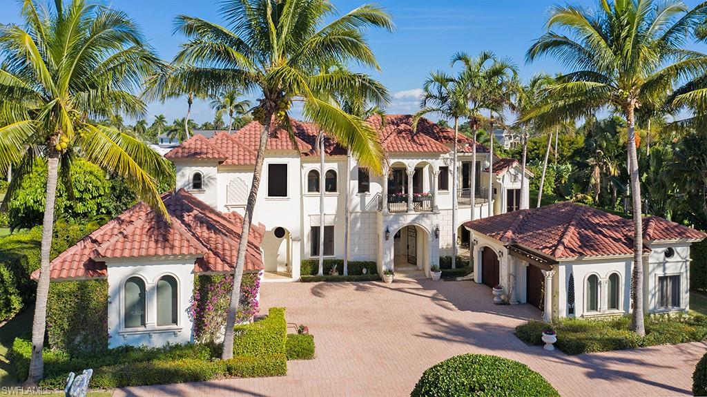 Elegant waterfront estate with breathtaking views down Old Harbour Cove located in close proximity to all of the remarkable amenities of the Port Royal Club. Designed for living life to the fullest and capable of accommodating a large family or multiple guests in total comfort, this home features a well planned kitchen, formal dining room, five bedrooms, theater, billiards room, fitness area, exceptional office, five garages, floating dock facilities, and a myriad of cozy spaces. Port Royal Club membership eligibility.