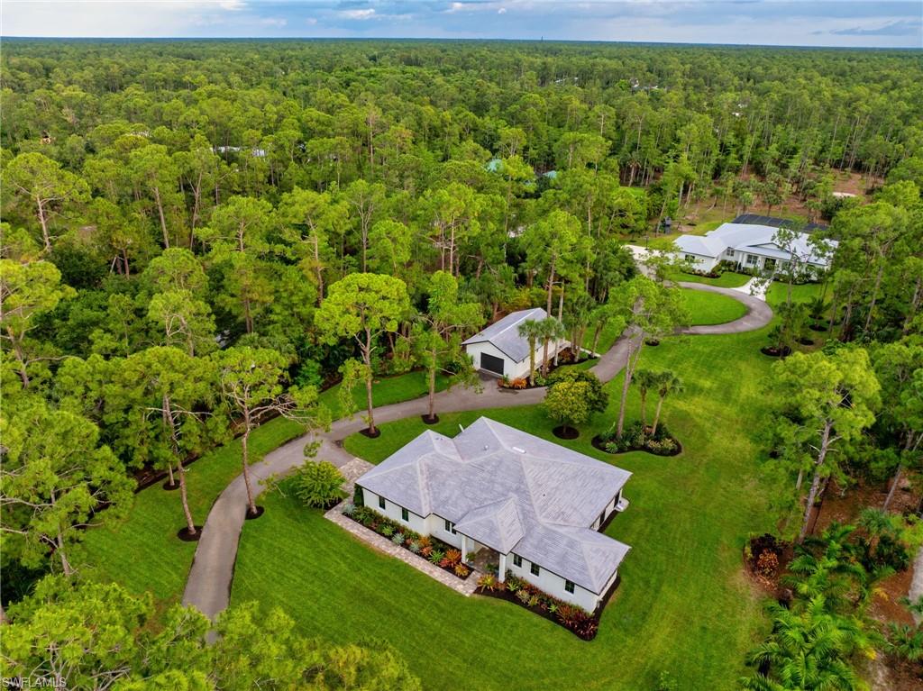 This 3.67 acres extremely manicured property is located in the much-desired neighborhood of Logan Woods. Very private, secluded, fully fenced and gated lot. The property has it ALL as it comes with its own GUEST HOUSE and its own WORKSHOP/STORAGE!

The meticulously maintained main home built in 2016 boasts 3,159 SQ FT of defined living space with 4 bedrooms, 2.5 baths and a 2+ attached garage. 
The 2,174 SQ FT screened lanai and heated pool were built in 2019 and offer a perfect outdoor area to entertain your guests and family. 

The guest house built in 2019 offers many options depending on your lifestyle: over 1,500 SQ FT of living area with 2 bedrooms and 2 baths for your guests, in-laws, live-in nanny, or older children who need more independence. The guest house has its own 1+ car garage and an extended lanai with remote screens.

1,000 sqft workshop fully renovated in 2019, with epoxy floor, new roof and AC… Perfect for a Man cave, an Art Studio or extra storage!

This lush landscape has many fruit trees: mangos, bananas, litchis, avocados, cherries, lemons and exotic plants.
Which makes it a real oasis!

Full house Reverse Osmosis system in the main house + in the guest house! 
80ft-deep well dug in 2019. New drainfield + new sceptic pump in 2023. New well pump in 2024.