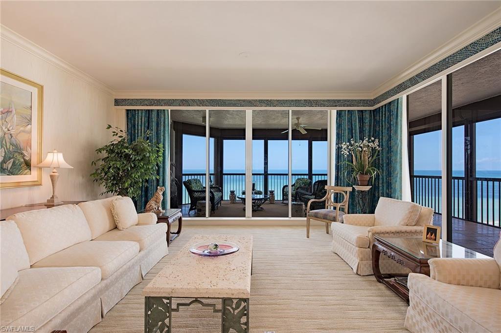 Gorgeous Gulf and beach views! Rarely available higher floor corner unit directly on the beach in the private gated community of Bay Colony in Pelican Bay. Featuring panoramic views of the Gulf of Mexico through floor-to-ceiling sliding glass this highly sought after floor plan welcomes you into an elegant entry foyer and spacious living area boasting nine-foot ceilings and separate dining area. Open kitchen and den area offer plenty of room for entertaining family and guests and three full bedrooms all with ensuite baths. A wonderful poolside cabana is included as well as two prime location under building parking spots. The Biltmore amenities include a gorgeous newer designer renovated lobby with 24-hour manned front desk, two guest suites, fitness center, social rooms, and a resort-style pool. Bay Colony residents enjoy the use of their own private newly renovated beach club and restaurant, a tennis club, as well as the use of the amenities of Pelican Bay. Private golf memberships are available separately.