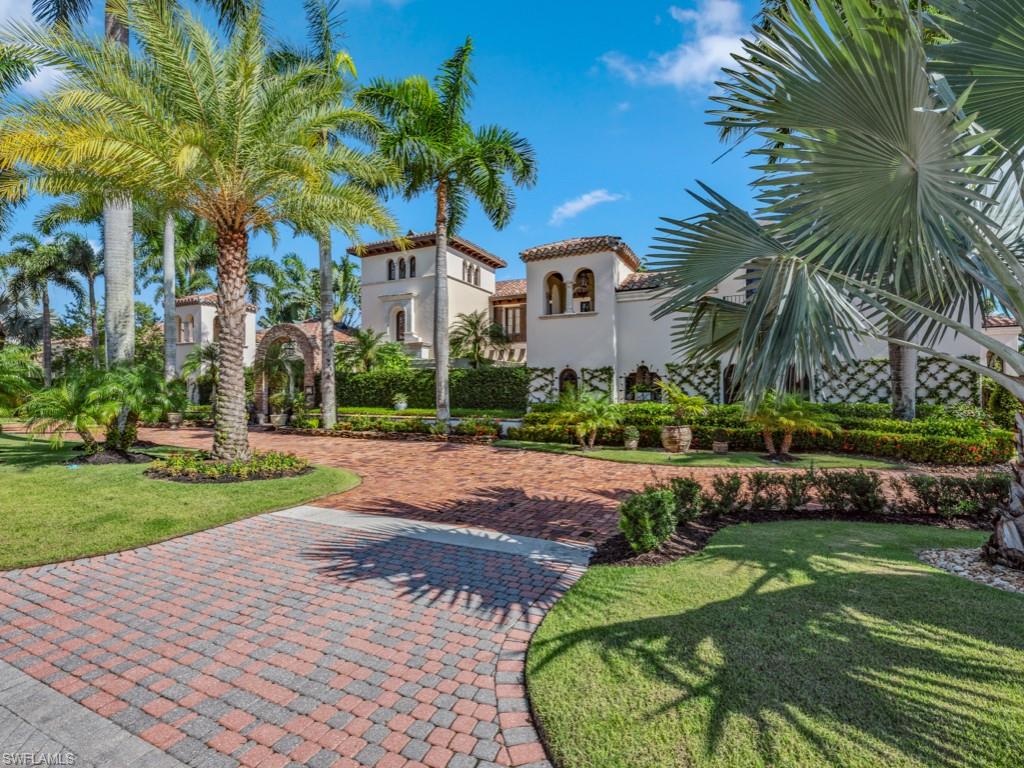Welcome to Villa Groveland. This exquisite property embodies the timeless elegance and charm of traditional Italian architecture, offering a serene retreat in the beautiful setting of Quail West Golf and Country Club.  Once inside, you experience a curated collection of art, history, and beauty that reflects the rich heritage of Italian culture.  An Italian villa is not just a home; its a timeless sanctuary that invites you to back to Italy with every moment spent within it’s walls. This home offers over 19,000 square feet of living space on a 180-by-177-foot lot. The property features six bedrooms, eight baths, a private guest house, office, game room, massage room and a four-car garage with golf cart storage. Once inside the villa you are immediately drawn to the dramatic two-story dining room featuring two fireplaces, large dining table for entertainment, with massive wooden beams and Juliet balconies. The restored wood came from a cannonball factory and was hand-planked to create 7,000 square feet of wood floors and massive wooden beams across the ceilings. Every room in the house has French doors, over 30 sets, which open to a veranda, loggia or balconies. The chef's inspired kitchen is the heart of the home, featuring a large island and top-of-the-line appliances. The family room and breakfast dining area open to the kitchen and just outside you will find a wishing well that cascades into a koi pond. The primary wing of the house includes a private massage room, luxurious primary suite, and outdoor spa and shower. The bocce ball court, swimming pool and numerous vignettes offer endless entertainment opportunities. The primary bedroom is located on the first floor.  Quail West offers 36-holes of pristine Arthur Hills-designed championship golf (Preserve and Lakes), a clubhouse with multiple dining options, and a full-service spa. The sports center area offers 8 clay hydro tennis courts, 4 pickleball courts, 4 bocce courts and a 2-story fitness & wellness building. Located on the 15th hole of the Preserve Course.