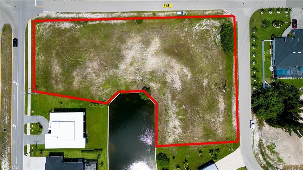 DON’T MISS THIS AMAZING OPPORTUNITY!  Imagine building the home of your dreams on this exceptional 4-LOT HOMESITE, perfectly positioned at the end of a freshwater canal in Southwest Cape Coral. Located in one of Cape Coral's up-and-coming areas, this property is surrounded by beautiful new homes. The property is MOSTLY CLEARED AND READY TO BUILD WITH SEAWALL ALREADY IN PLACE, saving you time and money in site preparation. Picture waking up each morning to sweeping, unobstructed water views; a peaceful canal gently shimmering in the sunlight, framed by swaying palms and lush tropical landscaping. This tranquil scene invites quiet coffee hours on a private dock, with kayaks gliding past, and stunning sunsets that paint the sky in vivid hues reflected on the water. This oversized homesite offers room for a luxurious waterfront home, expansive outdoor living spaces, a beautiful pool, a private guesthouse, and custom dockage. Its generous dimensions provide both privacy and the perfect setting for waterfront living. Experience the best of Cape Coral with serene canal-front views, abundant outdoor space, and the opportunity to create a personalized waterfront retreat.
The City of Cape Coral documentation indicates that no owl nests are present on the property (buyer to verify and do their own due diligence). Corner lots offer design flexibility, multiple driveway and garage options, and enhanced curb appeal with frontage on three streets. The EASTERN EXPOSURE brings abundant morning sunlight into your backyard oasis, creating bright, inviting outdoor living spaces. Ideal for a custom pool design, it offers consistent sunshine throughout the day. The surrounding area is well maintained and attractive, enhancing curb appeal and supporting long-term property values in a desirable neighborhood of quality homes. 
This amazing lot site already has CITY WATER AND SEWER IN PLACE.  No need for well and septic.  Your custom builder can connect the city utilities right away.  Ideally located within walking or biking distance to shopping, dining, schools, and parks, with convenient access to major roadways connecting you to Fort Myers and/or Punta Gorda and beyond. Enjoy abundant recreational opportunities nearby, including the Burnt Store boat ramp, golf courses, and community centers, as well as an easy drive to Sanibel, Captiva, and Fort Myers Beach. Whether building now or investing for the future, this property offers the flexibility and features today’s buyers are seeking—bring your builder and your vision. For the convenience of all parties, we request that all offers be submitted in writing on the most recent Florida Realtors Vacant Land Contract and accompanied by proof of funds. NO verbal offers are accepted. Residential lots of this grand size don’t happen often.  Make your future happen now!