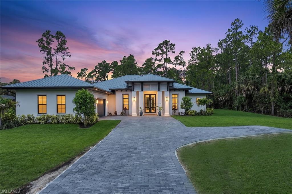 This Brand New Construction Home in Golden Gate Estates is Complete with Everything You Have Always Dreamed of!  Be the first to live in this incredible property, where every detail has been meticulously crafted to be a work of art.  At 3,451 square feet this home is filled with natural light and features soaring ceilings, 4 large Bedrooms, an Office, and a Fitness Room all on one level, giving you the space you've been looking for.  The kitchen is truly remarkable, with custom white cabinetry, gorgeous quartz countertops, top of the line appliances, huge island, double oven, 6 burner propane stove, a dedicated coffee station with espresso machine and bar.  The primary bedroom suite brings luxury resort and spa amenities into your home with designer finishes throughout, a grand double walk-in shower, separate soaking tub and sinks, and a hidden bidet inside a water closet. This spacious floor plan was created for entertaining and guests in mind.  The large sliding pocket door opens up the living area into a huge screened and covered outdoor oasis adding over 1,000 additional square feet of paradise.  This home is situated on a 2.27 Acre 100% Upland wooded lot, tucked halfway back on the property for added privacy with a beautiful brick paver driveway leading to the quiet end-road entrance.  Additional features include an attached showroom finished 3-Car Garage, whole house reverse osmosis water filtration system, built-in ceiling speakers throughout, a buried propane tank, impact resistant windows and doors, and a highly desired metal roof for added protection. Located conveniently in rural Golden Gate Estates with No-HOA, no restrictions or fees, while still just minutes from Downtown Naples and the white sandy beaches of the Gulf. This is the home you have been waiting for!