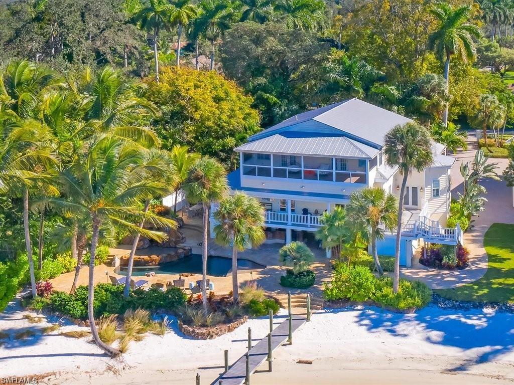 A rare offering along the Caloosahatchee River, this private waterfront estate delivers an unmatched blend of scale, seclusion, and resort-style living. One of the only properties in the area featuring a 130-foot private natural sand beach and an expansive 200-foot boardwalk dock with direct boating access, this is true Old Florida luxury redefined.

Spanning over 6 bedrooms and 6 bathrooms, the estate is designed for both grand entertaining and private retreat. The main residence offers 4 bedrooms and 5 bathrooms, while a fully renovated guest house provides 2 additional bedrooms, 1 bathroom, and its own living area, kitchen, and private balcony overlooking the water .

The outdoor experience is where this property truly separates itself. A custom-designed pool with waterfall spa, paired with a fully equipped poolside bar and entertainment area, creates a setting built for hosting. Lush, curated landscaping featuring palm trees, citrus, bamboo, orchids, and vibrant tropical plantings transforms the grounds into a serene, Zen-like riverfront oasis.

Inside, the home balances historic character with elevated finishes. A spacious gourmet kitchen features granite surfaces, custom cabinetry, and stainless steel appliances. Original 1910 fireplaces add warmth and authenticity to both the living room and primary suite, while Brazilian cherry hardwood floors run throughout the main residence.

Expansive wraparound balconies on both levels provide multiple vantage points to take in the water, with direct access from the primary and guest bedrooms upstairs. As the sun sets, automated landscape and exterior lighting create an entirely different ambiance, perfect for evening entertaining or quiet waterfront moments.

Whether enjoyed from the private beach, poolside, or elevated terraces, the sunsets here are nothing short of spectacular.

A true legacy property offering privacy, scale, and a lifestyle that simply cannot be replicated.