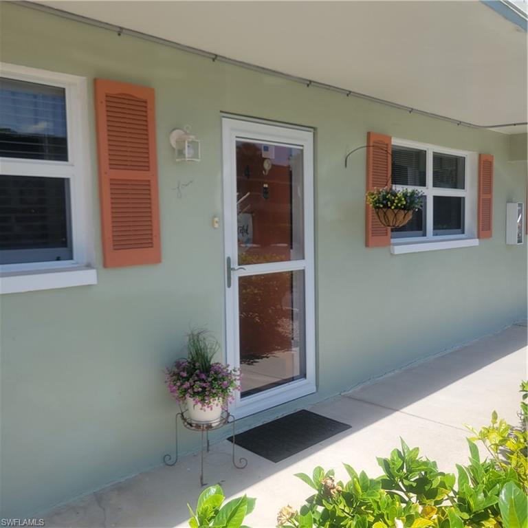 Affordable Naples condo that is updated and only 12 minutes to the beach! Fully furnished 2 bedroom, 2 bath with lanai is all you need to be happy and living your best life in SWFL! There is stylish electric wall fireplace for the occasional chilly evening and a wall mounted TV already in place above it. Most everything in the condo will stay, truly turnkey.  The community pool, tables, and grill, all with a canal view just short walk across the parking area. There is guest parking available, so it's easy to host guests. This would also make a great investment, with 3 leases per year, minimum 30 days. This is a 55+ community to reside within the unit, but you can be under 55 to purchase as an investment. This unit did not flood during Hurricane Ian and is protected by hurricane windows and manual shutters on the lanai to keep you feeling safe and sound. The location is 10 minutes from a ton of new developement extending 5th Ave S. It's close to Celebration Park, Sugden Park, shopping including chains like Hobby Lobby and Home Goods. It's also close to Publix, CVS, Walgreens. Don't miss this great opportunity!!