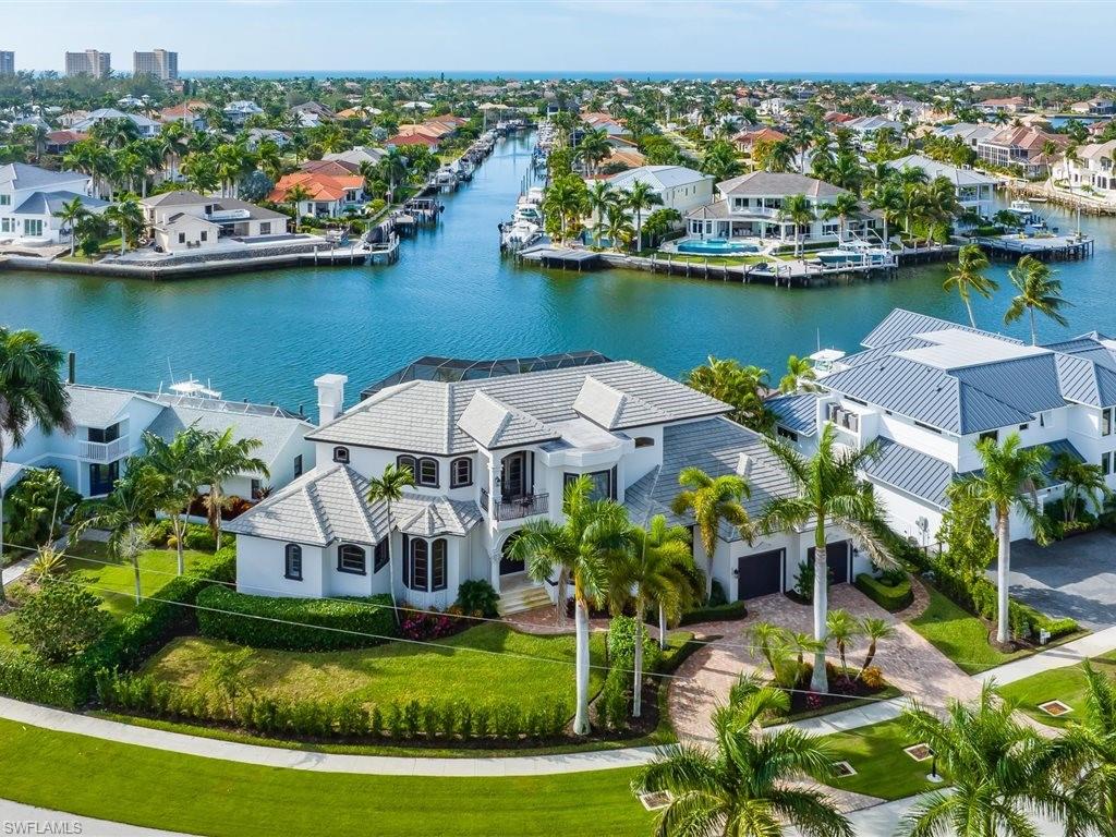 Experience southwest waterfront luxury in this architectural masterpiece, where timeless design meets unparalleled craftsmanship. This one-of-a-kind estate features an expansive open floor plan designed to capture dazzling southwest water views from nearly every room. Pocket sliding doors disappear to reveal an expansive deck, a resort-style pool and spa with a sun shelf, and lush tropical landscaping. Inside is a chef’s dream kitchen, equipped with custom cabinetry, top-tier appliances, a six-burner gas cooktop, and a convenient pot filler.  A custom marble staircase with wrought iron detailing leads to a theatre room, a cozy sitting area, and three en-suite bedrooms—each boasting its own private lanai. Located on a coveted Gulf-access canal, this home features a brand-new dock and a heavy-duty 30,000 lb lift. Enjoy hassle-free, deep-water access to the emerald waters of the Gulf, reachable in just minutes. There are so many more details that wouldn't fit into the description, you must come to see for yourself!