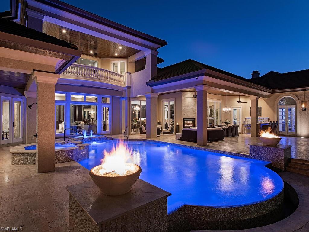H.127-Masterfully recreated & completely updated for entertaining and enjoyment with a fresh, light, elegant aesthetic! Stunning home offers multiple areas for gathering indoors and out, w/vast lake and golf course views. New flat tile roof in 2019 tops this tastefully appointed home, with wide plank wood and marble flooring, new cabinetry, plumbing fixtures, new gas fireplaces inside and out, lofty, detailed coffered ceilings and strategic, enhanced lighting & Sonos sound system adding to the ambiance. State-of-the-art chef’s kitchen & butler’s pantry feature all the best Wolf, Sub Zero, Thermador, Kohler and Bosch appliances & fixtures plus a warming drawer, wine cellar & every imaginable convenience & and smart home technology. Outside entertaining is enchanting with the magnificent 4,000 sq ft lanai, fully equipped outdoor kitchen, infinity-edge, LED lighted saltwater pool and spa with Italian glass tile surround, fire pots & water features. Large travertine topped, gas fire pit table provides another seating area with torpedo flame up-lighting beneath a pergola. Bay Laurel Estates is a sought-after gated neighborhood within the prestigious Pelican Marsh Country Club community.