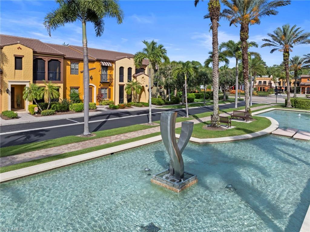 Stunning TURNKEY condo offering the perfect blend of luxury, comfort & resort-style living. Ideally situated steps from The Village Center amenities, this UPDATED residence features tranquil views of the reflecting pool boulevard w/elegant WATER FEATURES & lush tropical landscaping. This light-filled open floor plan w/split-bedroom design offers 3 bedrooms, 2 full baths & 1771 sqft AC/2439 total sqft. Built w/CONCRETE BLOCK CONSTRUCTION on both levels, the home also features a NEW ROOF, NEW TILE FLOORS, IMPACT GLASS windows/doors & many high-end upgrades throughout.The inviting entry welcomes you w/a covered & enclosed front porch & engineered hardwood stairs leading to the main living area. The open great room & dining area showcase elegant lighting, electric FLOOR OUTLET, & French doors leading to the expansive NO-SEE-UM SCREEN LANAI overlooking the water feature boulevard. The kitchen is beautifully appointed w/QUARTZ COUNTERS, TILE BACKSPLASH, shaker cabinetry, PENDANT LIGHTS, stainless steel LG-IQ SMART APPLIANCES, CONVECTION SELF-CLEANING OVEN, large island w/breakfast bar & single-bowl sink. The luxurious primary suite offers a true retreat w/French doors leading to a charming Juliet balcony w/WATER VIEWS, CROWN MOLDING, chandelier & direct access to the lanai. The REMODELED SPA INSPIRED BATH features a floor-to-ceiling tiled WALK-IN SHOWER w/RAIN SHOWER HEAD & handheld fixture, shower niche,, QUARTZ double vanity, linen closet w/wWOOD VENTED SHELVING & private water closet. The oversized WALK-IN CLOSET includes CUSTOM CLOSET ORGANIZERS. A thoughtfully designed split-bedroom layout creates privacy while offering a dedicated workspace area complete with BUILT-IN DESK w/QUARTZ COUNTERTOP. Secondary bedrooms feature ceiling fans, and spacious closets. Additional highlights include updated hall bath finishes, front-load washer and dryer, wallpaper accents, SMART HOME AUTOMATION, SECURITY SYSTEM & TURNKEY furnishings. The oversized 2-car garage is equally impressive w/a heavy-duty EPOXY FLOOR, STORAGE SHELVES, SURGE PROTECTOR, GENERATOR & HOSE BIB. Recent upgrades provide peace of mind & modern convenience, including: electronic FRONT DOOR KEYPAD (2026), NO-SEE-UM lanai screen (2025), LG-IQ SMART APPLIANCES (2024), AC SYSTEM (2021), WATER HEATER(2015). Residents enjoy exceptional resort-style amenities at The Village Center including a HEATED POOL, HOT TUB, poolside food & beverage service, FITNESS CENTER, aerobics studio, MOVIE THEATER, PUB, BISTRO, ice cream &, internet café, library, TENNIS, PICKLEBALL, BOCCE, basketball, volleyball, and nearby GOLF opportunities. Optional membership to The Player’s Club & Spa is also available. HOA fees include internet, cable TV, water, sewer, trash pickup, lawn & landscape maintenance & irrigation. This extraordinary residence offers the ideal combination of luxury upgrades, smart-home convenience, turnkey living, and unmatched community amenities — all in a PRIME LOCATION. GREAT INVESTMENT OPPORTUNITY!