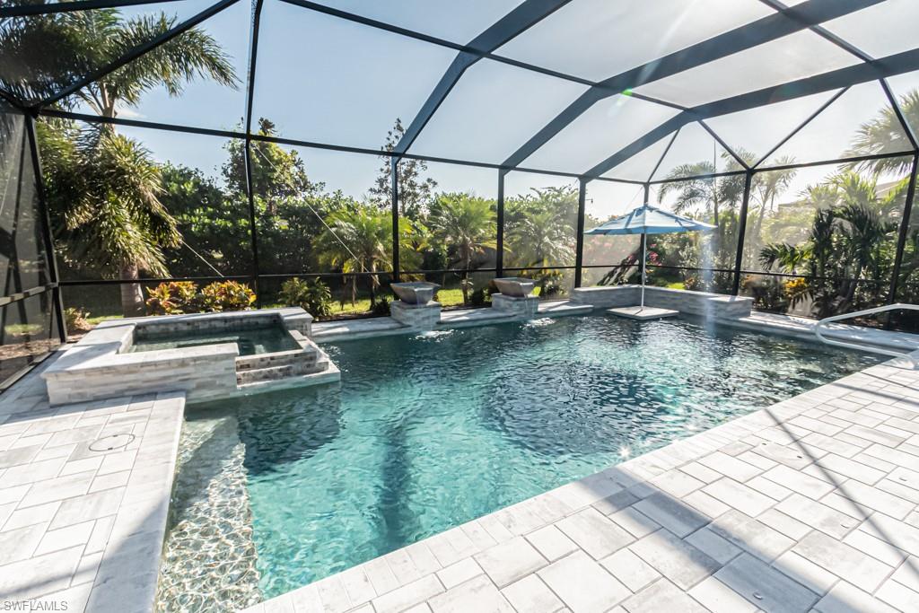 You want it all??  Here it is and it's just STUNNING. Highly desirable Islamorada model - 3 bedrooms, 3 baths plus den. This home is loaded with upgrades including;  Tile throughout, 5" base boards, 8' doors, crowns in every room, French doors in the den, Plantations shutters throughout the home, drop-down hurricane protection on the lanai, mounted lanai heaters, rimless shower doors, high-end fans and lighting, custom summer kitchen with grill and fridge, LG washer/dryer 2021,  HVAC 2022. and the POOL....Oh my - what a pool.  Nearly 2000 sq ft lanai with custom salt water pool/spa with  'swim table/seating'.  The high-end Frontgate lanai seating is available for sale.  See confidential notes.  Pelican Preserve is an active adult community offering a vast array of amenities; Golf, Tennis, Pickleball, Spa Services, Bocce, Theater, Hobby rooms, Library, Wood-working, indoor and out-door pools.  Golf is optional and memberships are available.