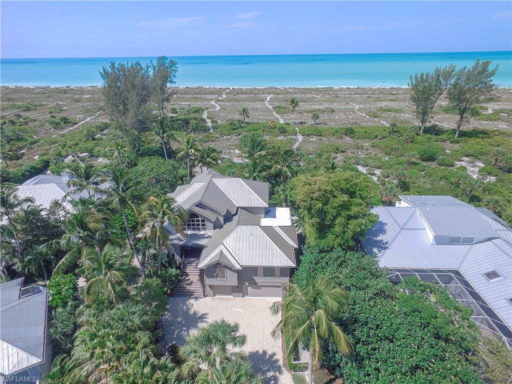 Located within the Gulf Ridge Community is this stunning Gulf Front estate home featuring 6 BR plus Den & 4.5 BTH, with endless panoramic views of sparkling Gulf waters and sunset skies, this meticulously maintained home offers all the space needed for privacy and tranquility. Enjoy oversized rooms and spaces for entertaining with open/screened lanais, large family room, lush tropical surroundings and private winding path to one of the Sanibel’s most beautiful beaches. 2nd floor master retreat features a cathedral ceiling and private deck to enjoy the tropical views. Additional spacious guest suite and BTH on this level. Main living level has a guest master suite w/ open deck and stunning gulf views. Separate guest area w/ 3 BR & BTH offers total privacy for your guests. Formal dining room overlooks the sparkling Gulf waters and large kitchen nearby are just a few more unbelievable aspects of this magnificent home. Enjoy the community pool with tennis court just steps from your door.