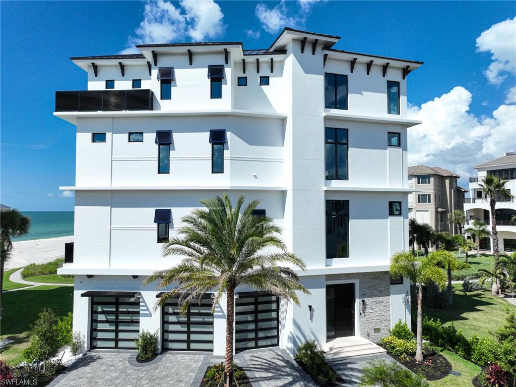 This 4 Story 6/7 Bedroom 9 bath just completed Barefoot Beach home with over 10,000 Sq Ft total living area and over 6,000+ AC area took 3 years to complete! Club at Barefoot Beach membership with very rare NO WAIT!  No expense was spared to create this amazing coastal contemporary beach home that features the latest in exterior and interior design and technology. The minute you reach the top stair to the main living level all you see through this amazing home is the white sand and turquoise water of the Gulf. The open floor plan provides those wide views from the dining area, kitchen, great room, bar which all open to the huge covered lanai, and sun deck around the elevated swimming pool & spa with a negative edge over the beach.  The 12’ ceilings with incredible details, 10’ sliders, transom & picture windows bring in massive amount of light to enhance the views and living experience.  The coastal contemporary interior design throughout the home showcases the latest & highest quality finishes and furnishings available. The control 4 smart home, complete audio visual with latest in smart tv technology and state of the art security system with cameras, whole house generator plus elevator to all levels assure the best in living.  Every room has custom ceiling and/or wall designs including beams, tongue & groove, ship lap with millwork with cabinet quality.  The floating staircase to all 4 levels features wide wood treads and glass railings.  The chef’s kitchen includes Wolf gas range, Subzero refrigerator/freezer, oversized sink with two faucets, custom cabinetry, two large islands with seating for 8 providing the best in cooking, entertaining or large catered gatherings. The great room & dining features a large bar area with full size “True” beverage refrigerator & glass wine room.  The large covered lanai features electric screens & shutters, a large sit at bar with sink, refrigerator summer kitchen with gas grill & hood, a pool bath, beach/pool laundry and a gas fire place with big screen tv above - all with out of this world gulf views over the pool. The Owner’s bedroom suite and deck sit right over the pool & beach. The bath has wall of his and her vanity & linen cabinets, oversized shower with his & her fixtures, rain head and relaxation bench. The free standing tub sits right at large picture windows overlooking the gulf. The very custom closet will handle all your clothes. The cloud room/den/flex room has large deck big screen tv and bath. The five large guest rooms are all finished and furnished to the same level as the rest of the home and the guest baths could be master baths in most homes. The exterior design offers outstanding street appeal including the 3 custom glass garage doors and solid wood 10’ entrance door.  Barefoot Beach gated community amenities: 24 hour guards & patrols, Clubhouse with fitness, tennis, pickleball, on site Manager & beach garden pool, spa & firepit. Boat Dock Available.