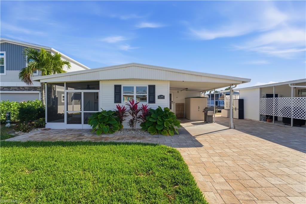 A charming canal-front manufactured home nestled in the welcoming Bayside Estates community. Boat lift and dock are ready for your boat.  This delightful 2-bedroom + den, 2-bath retreat spans approximately 1,458 square feet and sits on a cozy 3,920 sq ft lot. Sip your coffee from the porch and watch the dolphins play.

Step into a bright, airy layout that flows effortlessly into a screened porch and private patio—perfect for morning coffee or evening relaxation. The lush landscaping and direct canal access make this home a tropical oasis for boating enthusiasts and those seeking serene waterfront living. 

Bayside Estates offers a vibrant, active lifestyle with amenities like a clubhouse, pool, tennis and pickleball courts, shuffleboard, spa/hot tub, and more—all included in the HOA. 

Conveniently located just minutes from Fort Myers Beach, you’ll enjoy easy access to local favorites such as Bayfront Bistro, Publix Super Market, Snook Bight Marina, and many more.