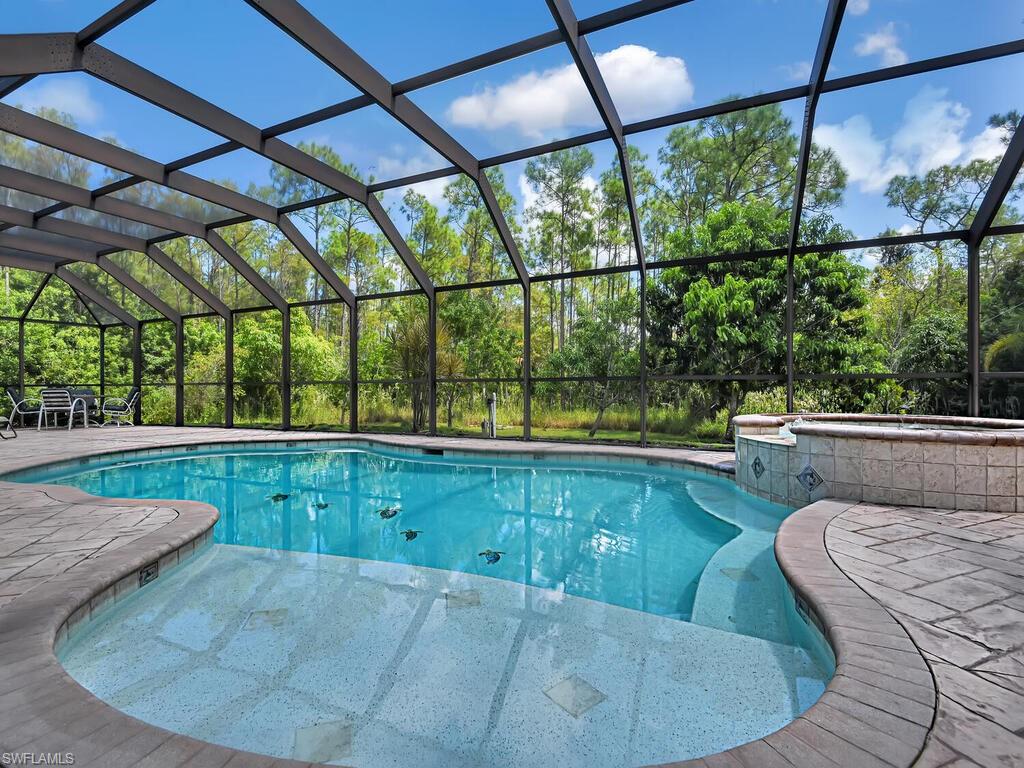 Tranquil setting, GUEST HOUSE, pool/spa, fruit trees and 3,000 sq ft main living! What more could you want on 1.25 acres of land with no HOA or restrictions. Looking for privacy and space? This home is perfect for you and invites an additional rental income opportunity featuring a 728 sq ft guest house with a living area, full kitchen, bathroom, bedroom and den. The main home boasts an oversized master bedroom with separate sitting area and access to a BONUS ROOM which would make for a wonderful nursery or workspace. Open kitchen, split floorplan, granite and tile throughout the main with luxury vinyl floor coverings in the bedrooms. There is also an additional shower in the utility room for pool guests. Landscape lighting and a fully paved drive to allow for ample guest parking. Complete with oversized pool cage and hot tub. Live worry free with newer mechanicals.  THREE A/C units (2019, 2019,2014), ROOF 2016.