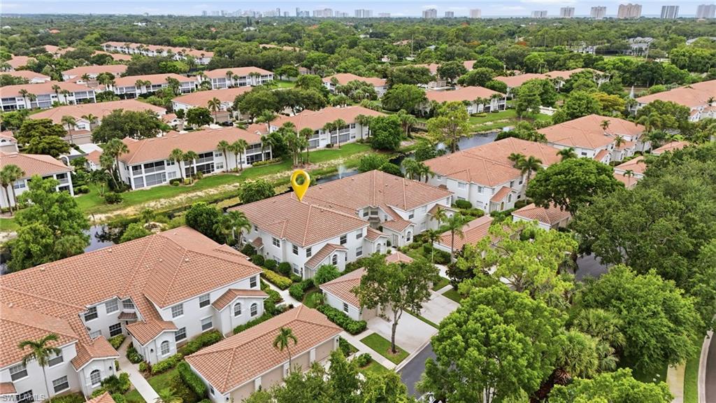 Enjoy peaceful lake views and abundant natural light from this beautifully maintained second-floor end-unit residence in the highly desirable Calusa Bay North community. Featuring two bedrooms, a versatile den, two bathrooms, a private one-car garage, and in-unit laundry, this thoughtfully designed home combines comfortable living with the privacy and spacious feel that Calusa Bay provides.

Large windows throughout the residence fill the interior with natural light, while the desirable south-facing screened lanai serves as a tranquil extension of the living space, offering abundant sunshine and the perfect setting to enjoy morning coffee or unwind overlooking the lake. Furnishings are negotiable, allowing for an easy transition into seasonal or year-round Naples living.

Owner enhancements include updated flooring throughout the main living areas and bathrooms, interior doors, baseboards, appliances, lighting fixtures, and lanai hurricane shutters, contributing to the home's polished and well-maintained appeal.

Residents of Calusa Bay enjoy an exceptional lifestyle within a gated, beautifully landscaped community featuring sparkling lakes, lush tropical surroundings, and professional on-site management. Community amenities include two pools, including a lap pool and spa, a fitness center, clubhouse, scenic walking paths, a fishing pier and sun deck overlooking the water, and two lighted Har-Tru tennis courts. Further peace of mind comes from the community's newer roofs, while the prime North Naples location places residents just minutes from the beach, Mercato, Waterside Shops, Downtown Naples, and an array of dining, shopping, and entertainment destinations. This residence presents an exceptional combination of comfort, convenience, and coastal living.