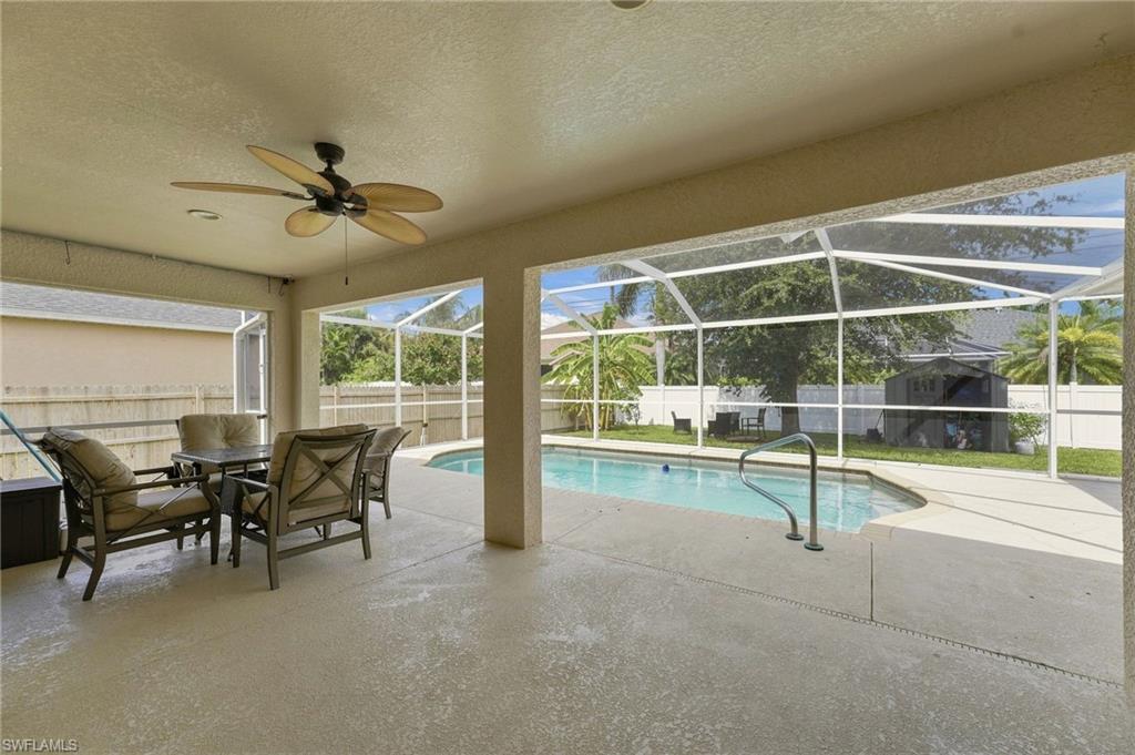 Step into this well-maintained 3-bedroom, 2-bath pool home offering over 2,000 square feet of living space in one of Southwest Cape Coral's most desirable locations. Designed for both everyday living and entertaining, the split floor plan features a separate living room and family room, a formal dining area, and a spacious kitchen with granite countertops, a large center island, abundant cabinetry, and newer stainless steel appliances including the range, refrigerator, and dishwasher. The heated, screened pool overlooks a private, fully fenced backyard with mature fruit trees, creating the perfect setting to relax or host family and friends. Recent updates provide peace of mind and added value, including a new roof (2022), new A/C (2021), fresh interior paint, new flooring in the guest bedrooms, newer toilets, and a reverse osmosis water filtration system under the kitchen sink. The spacious primary suite and generous guest bedrooms make this home ideal for families, seasonal residents, or anyone looking for extra room to spread out. Conveniently located in Southwest Cape Coral, this home is just minutes from Cape Harbour, Tarpon Point Marina, waterfront dining, shopping, grocery stores, parks, highly rated schools, and offers easy access to Fort Myers and the beaches. Whether you're searching for a primary residence, vacation home, or investment property, this move-in ready pool home combines location, updates, and lifestyle in one exceptional package.