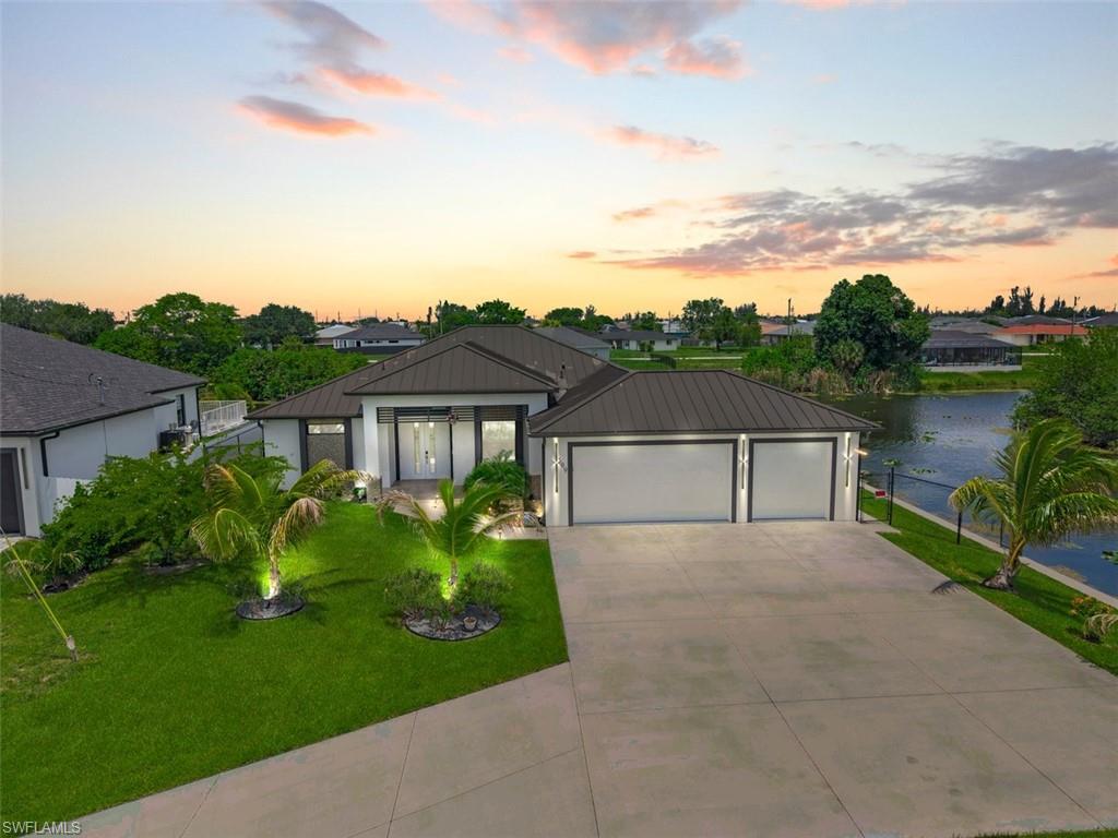 Why wait to build when you can move into this stunning waterfront home built in late 2023? Situated on an oversized 12,512-square-foot lot with western exposure on a freshwater intersecting canal, this exceptional property offers an impressive 232.79 feet of seawall, breathtaking sunset views, and nearly 2,000 square feet of thoughtfully designed living space.

Featuring 3 spacious bedrooms, a den perfect for a home office or guest space, 3 full bathrooms, and an oversized 3-car garage with a mini-split A/C system, this home was designed to combine luxury, comfort, and functionality.

From the seamless metal roof and impact-resistant windows and doors to the soaring ceilings, 8-foot interior doors, tile flooring throughout, and soundproof wall construction, every detail reflects quality craftsmanship and modern design.

The gourmet kitchen is sure to impress, showcasing beautiful quartzite countertops, Samsung Bespoke appliances, and an open-concept layout that seamlessly connects the living, dining, and outdoor entertaining areas.

Step outside to your private resort-style retreat featuring a spacious travertine lanai, fully equipped outdoor kitchen, heated pool, and spa. Whether you're hosting family and friends or enjoying a peaceful evening overlooking the water, this outdoor oasis was designed for unforgettable memories.

Additional benefits include NO flood insurance required, city water, sewer, and irrigation, with all assessments paid in full by the seller at closing.

Luxury waterfront homes with this much seawall frontage, modern construction, premium finishes, and exceptional outdoor living are rarely available. Schedule your private showing today and experience the Florida lifestyle you've been dreaming of.

Certain photos have been virtually staged. Furniture and décor depicted are not included in the sale of the property.
