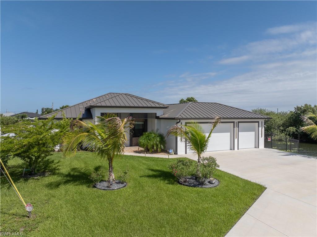 Why wait to build when you can own this stunning waterfront home built in late 2023? 
Perfectly positioned on an oversized 12,512-square-foot lot with western exposure on a freshwater intersecting canal, this exceptional property offers an impressive 232.79 feet of seawall, breathtaking sunset views, and nearly 2,000 square feet of thoughtfully designed living space.

From the moment you arrive, you'll appreciate the modern architecture, seamless metal roof, oversized 3-car garage with mini-split A/C, and the attention to detail found throughout. Inside, soaring ceilings, 8-foot doors, marble flooring throughout, impact-resistant windows and doors, and soundproof walls for comfortable living environment.

The heart of the home is the beautifully designed kitchen featuring elegant quartzite countertops and premium Samsung Bespoke appliances, perfectly suited for both everyday living and entertaining. The open-concept floor plan flows effortlessly to the outdoor living area, where Florida living truly comes to life.

Imagine relaxing in your heated pool and spa, entertaining guests in the outdoor kitchen, or enjoying a quiet evening on the expansive travertine lanai while watching spectacular sunsets over the water. This private backyard oasis was designed to be enjoyed year-round.

Additional benefits include NO flood insurance required, city water, sewer, and irrigation, with all assessments paid in full by the seller at closing.

Homes with this combination of modern construction, premium finishes, oversized waterfront frontage, and incredible outdoor living are rarely available. Schedule your private showing today and experience everything this exceptional property has to offer.