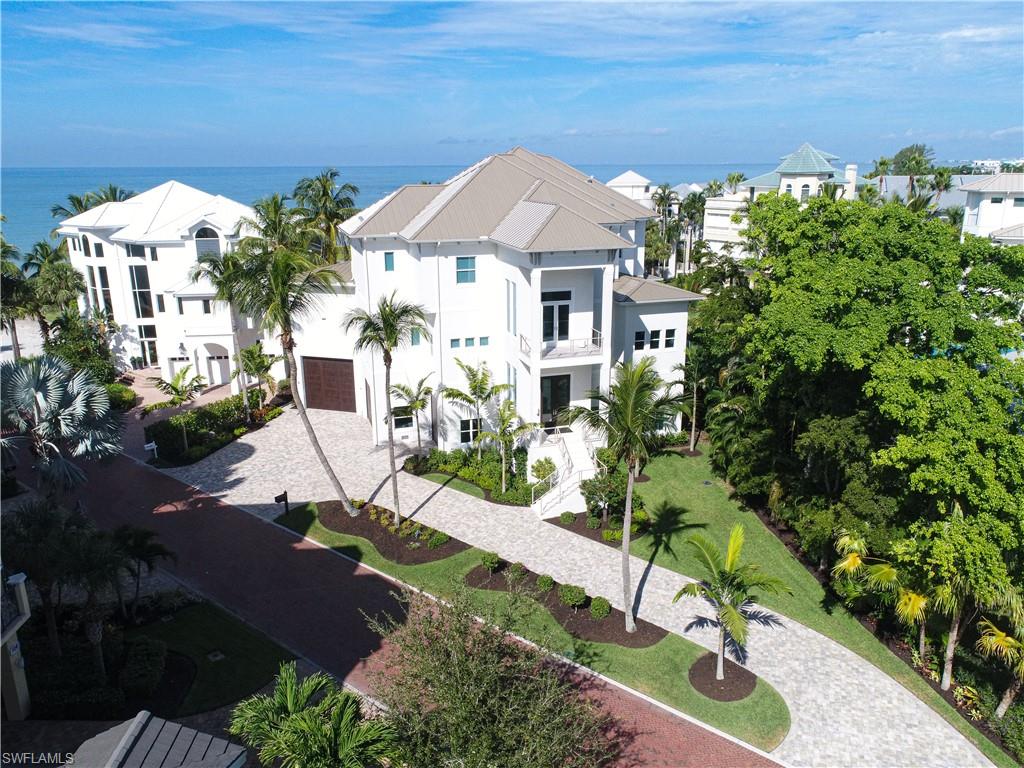 There is no equal to this Gulf of Mexico home sitting on one of the largest double beach lot sites in Barefoot Beach. The home was constructed using the original concrete pilings/slab & expanded to create this 3 Story home featuring a 2,038 sq ft lanai/decks, electric screens and shutters, massive outdoor kitchen area w/grill, fireplace w/tv overlooking tropical beach garden, pool & the Gulf. An amazing Chef's kitchen w/approx 11'x6' island, 60" Wolfe range, SubZero refrigerator & freezer, double dishwashers, custom cabinetry w/solid maple boxes, hidden pantry and 2.5" Marble countertops. 3' ceilings, 8' interior doors w/2' transoms, private elevator, 6 full 2 half baths, Great room features wall of 10' sliders to deck, large dining room, 4 bedroom suites with baths plus amazing Master bedroom & bath w/wide Gulf views & supersized closet, 3 laundry rooms, media room & office on the Gulf w/access to the master, media & private bath. 5 car garage w/42' RV/boat garage, 150' circular driveway, tropical landscaped yard. Very large gym room with TVs. Gym equipment available as a separate purchase from sales contract.  Designer furniture & furnishings package included. Gated + amenities.