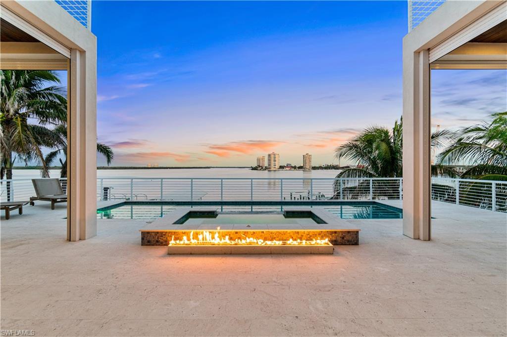 Exceptional 2019-built masterpiece on the coveted South end of Estero Island. Offering some of the most expansive and breathtaking bay views the island has to offer, this residence is the epitome of coastal luxury living. A haven for boating enthusiasts, it boasts direct access to the Gulf with just a two-minute boat ride. The property features a private dock, a 12,000 lb boat lift that previously accommodated a 40-foot boat, and a jet ski lift. Located just a 7-minute (0.3-mile) stroll from deeded beach access exclusive to a limited number of South end bayside residents, this home is perfectly positioned for both beach and boat lovers. No details were overlooked while meticulously crafting this architectural marvel, from beautiful oak flooring to inverted tray ceilings with custom lighting. Inside, the expansive open layout includes 4 spacious bedrooms, 4 full bathrooms, 2 half-baths, dual laundries, and a garage that has ample space for 6+ cars. Step outside to your own backyard oasis, where an expansive pool deck awaits, featuring an elevated pool with a sun shelf, spa, a fireplace, a summer kitchen, a pool bath, and a bar area with swinging chairs and seating – perfect for entertaining or relaxing. The gourmet chef’s kitchen is equipped with high-end granite waterfall countertops, sleek white cabinetry, premium Jenn-Air appliances, and a butler’s pantry. The luxurious primary suite offers sweeping Bay views, a private lanai, dual walk-in closets, and a spa-like bathroom with dual vanities, a freestanding tub, and a shower with multiple shower heads for ultimate relaxation. Additional features include a whole-house filtration system, a 500 lb buried propane tank, a private elevator, hurricane impact windows and sliders, electric storm shutters, interior electric screens, a Lutron lighting system, and a surround sound system. Prime location on a peaceful stretch of South Estero Island close to many fantastic restaurants and easy access to Lovers Key/Bonita Beach. This is the pinnacle of waterfront living.
