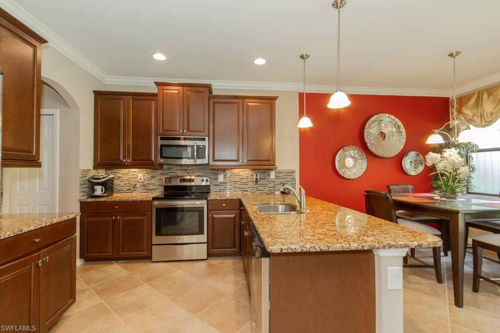 Stunning and immaculate town-home with amazing upgrades offering 3 BR and 2.5 baths with a lovely landscaped view.  This home has tile on the diagonal in the main areas downstairs and the bathrooms upstairs, Bamboo flooring in the 3rd Bedroom/Den and Brazilian Cherry flooring in the Master Bedroom. The kitchen is terrific with a large granite counter that doubles as a breakfast bar, tile backsplash and stainless steel appliances. Custom paintwork throughout the home, and custom draperies were made for this exceptional residence-all are included.  The lanai offers privacy/sun blinds (on all sides) and a lovely view of the orange tree! This home also has a 2 car garage, paved driveway and tile roof and is conveniently located near local shops and restaurants.  Seller will sell the Dining Room table and chairs and also the Guest Bedroom bed, dresser and night stand.