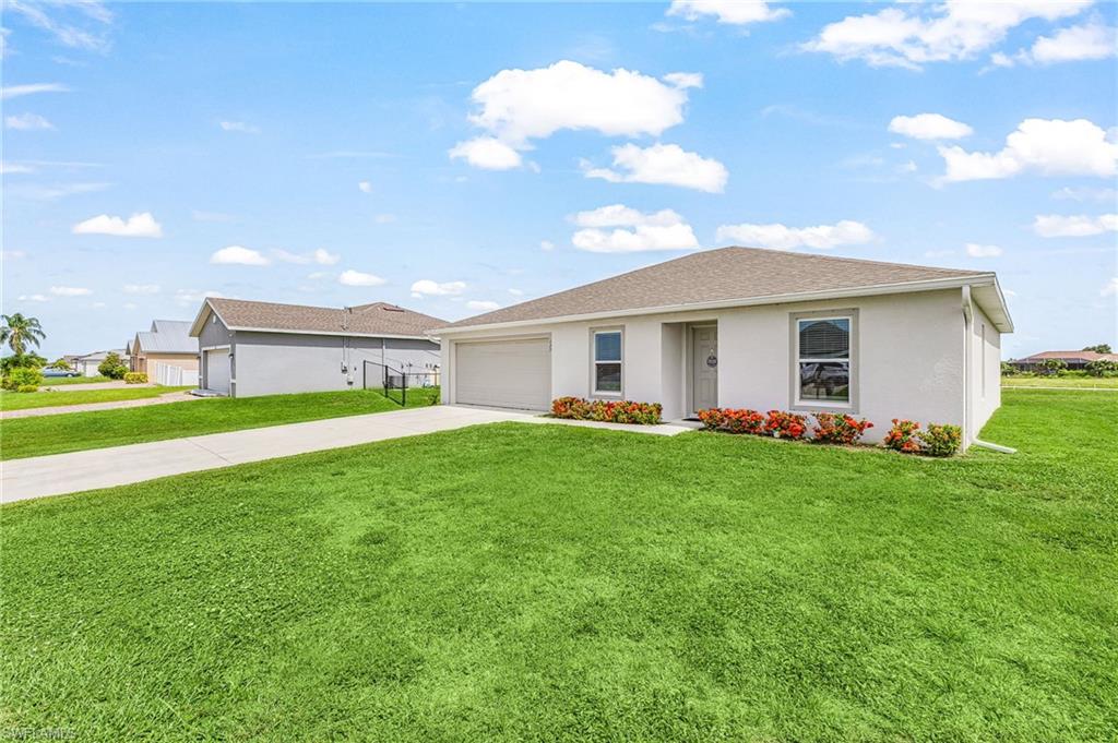 Charming, newer clean & affordable 3-bedroom, 2-bath home with a 2-car garage in a desirable NW Cape Coral location—and best of all, NOT in a flood zone! This thoughtfully designed split-bedroom floor plan offers both comfort and functionality, featuring a spacious great room with an open-concept kitchen equipped with white cabinetry, stainless steel appliances, and a spacious breakfast bar that's perfect for entertaining and everyday living. A separate dining room provides the ideal space for family dinners or hosting guests, while the versatile den/family room offers endless possibilities as a home office, media room, or additional living area. The primary suite is tucked away from the guest bedrooms, creating a peaceful retreat. The large backyard offers plenty of space for a future pool. This property features irrigation. Septic just pumped out 2025. Conveniently located near Pine Island Road, you’ll enjoy easy access to shopping, dining, entertainment, and more. Don't miss this wonderful opportunity to own a move-in ready home in one of Cape Coral's most sought-after locations.
