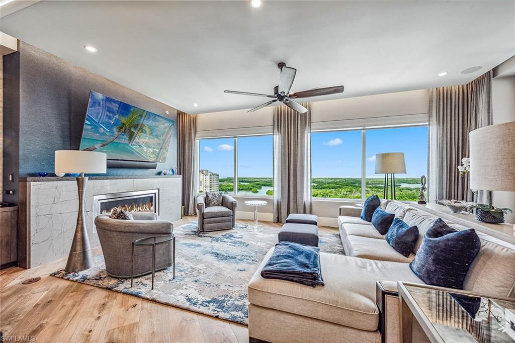 Naples coastal living offers luxury, comfort, and style, promising the good life with an array of aquatic activities including boats, a yacht club, and beaches, as well as moments of peace, grace, and beauty. Hardwood plank flooring, marble, and lush, sculpted pile carpets distinguish this residence. The chef’s kitchen features top-of-the-line appliances with a Wolf oven, propane gas cooktop, Zephyr elevated overhead fan, and a Sharp microwave oven for added convenience, anchored by a SubZero refrigerator. Marble accents the baths and facilities, while rich cabinetry and fully-fitted walk-in closets ensure convenience and allure. Exclusive to the penthouse is a select propane fireplace and a large wet bar with a 90-bottle wine chiller for entertaining, along with a lanai for grilling. The Control 4 automation system refines lighting, music, and television. Enjoy views of Naples' newest golf course to the east and the marina basin and Gulf to the west. The building offers three guest suites, billiards, a party room, sky lounge, theater room, and concierge services. Additionally, a private two-car garage is included. Aqua, located near Pelican Isle Yacht Club and Mercato Shops, promises to spoil you with the Gulf life and the amenities of central Naples.