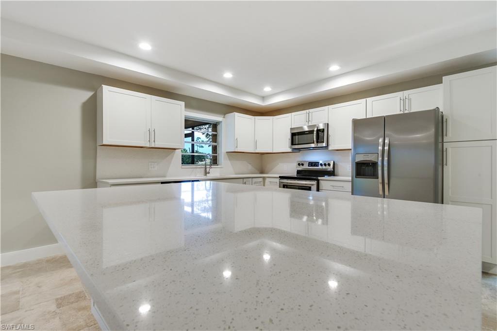 Stunning renovated home in highly sought after non-gated, deeded neighborhood of Greenwood @ Palm River! Brand New Roof!! Nestling up to a 2.5 acre preserve/park area with walking path and a community pool gives this 3 bedroom home a wonderful peaceful & serene setting. Completely remodeled with taste from ceiling to floor and wall-to-wall and featuring an open concept kitchen with movable island, quartz counter-tops and back splash & new stainless steel appliances, freshly painted inside & out, gorgeous Travertine flooring throughout, front entryway w/ Frank Lloyd Wright appeal, disappearing slider system leading from great room to lanai, tall base & custom trim on windows, new fans & light fixtures, and new landscaping. You will love the outdoor living space this home has to offer w/ new picture window screening to enjoy the beautiful view of the preserve/park area and enough room for an outdoor dining set & lounging chairs. Storm ready home w/ some impact glass windows, accordion shutters on lanai, and clear manual shutters for the rest of the home. Absolutely a rare find-"like new" home with an unbeatable setting!