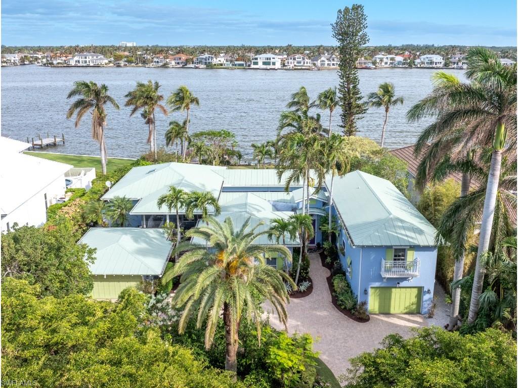 Discover one of the most coveted locations in Naples, Florida, with this extraordinary waterfront property offering breathtaking wide and long water views of Naples Bay. Residents here enjoy stunning sunrises over the water and the warm, radiant hues of sunsets that fill the evening skies—creating an ever-changing masterpiece of natural beauty. Ideally situated just minutes from the vibrant shoppes, restaurants, and galleries of 3rd Street South in Old Naples, this location offers both tranquility and convenience in equal measure. An unusually large Aqualane Shores property, the lot consists of approximately 100 feet of prime water frontage and 195 feet of depth per the plat—offering an exceptional building envelope for your dream home. The existing older home is being sold in its "As-Is" condition, presenting a rare opportunity to create a custom residence that meets today’s highest standards. With its unparalleled location, expansive lot size, and one of the finest views in all of Naples, this is a once-in-a-lifetime chance to build your waterfront oasis in one of the most sought-after neighborhoods in Naples, Florida.
