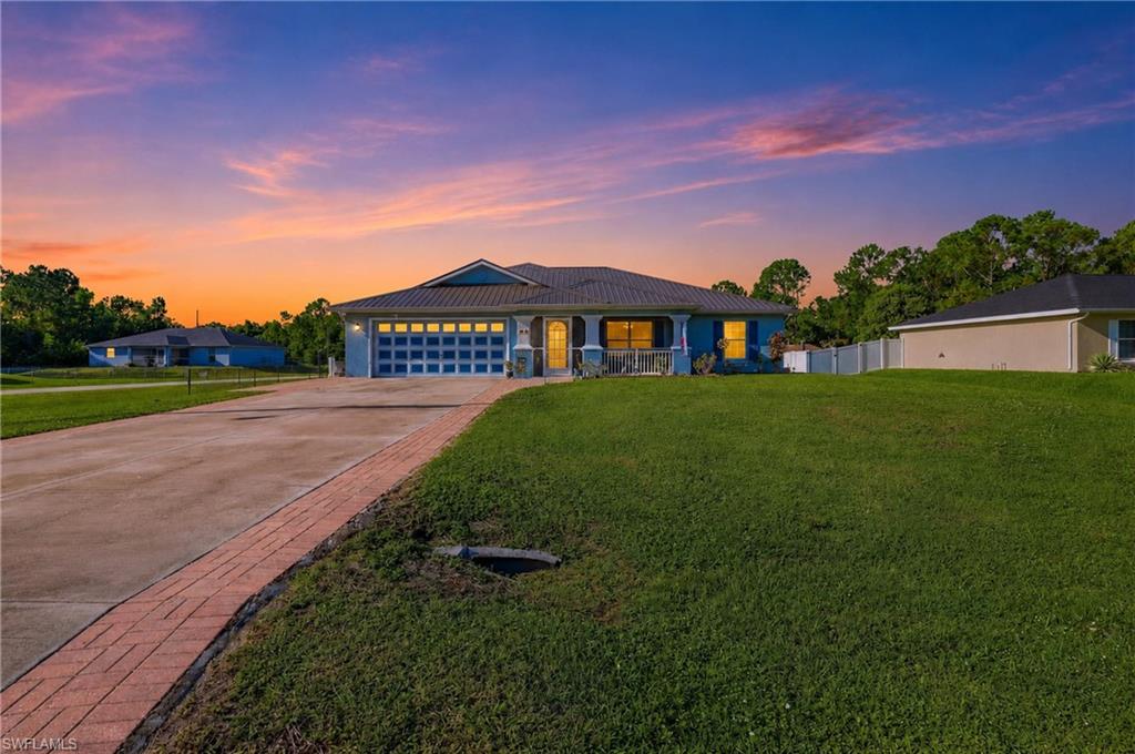 Luxuriously renovated and truly move-in ready! Like new, but this isn't another cookie-cutter builder grade home. Countless upgrades that make this home stand out include major upgrades and updates offering peace of mind such as 2023 metal roof, fully remodeled kitchen and baths, new LVT plank flooring throughout, HVAC in 2022, hot water heater in 2026 and septic pumped 08/2025. The entire home has been gorgeously remodeled over the last 5 years with thoughtful inclusions such as smart home features, remote-controlled ceiling fans, LG front-load laundry & kitchen black stainless steel ThinQ appliances, soft close cabinets & drawers with several pull outs, 2” faux wood blinds throughout and a backyard built for entertaining includes a 12’ x 24’ above ground pool with pvc pump plumbing, wood deck with metal roof gazebo & separate grill gazebos. Situated on a fenced-in spacious corner lot with no flood zone in the desirable Mirror Lakes area of Lehigh Acres, step inside to discover a bright, open floor plan featuring the same luxury vinyl plank flooring throughout for a cohesive flow, soaring vaulted ceilings, and elegantly styled finishes from room to room. The heart of the home is a stunning, fully remodeled kitchen showcasing an extended cabinet pantry, crown-molding topped cabinetry, eye-catching tiled backsplash design, french-door fridge w/climate control drawer, microwave/oven wall combo, 5 burner smooth cooktop, vented range hood and abundant prep space—perfect for everything from everyday meals to entertaining family and friends. The spacious primary suite is a true retreat, highlighted by a beautifully renovated spa-inspired bathroom featuring a freestanding soaking tub, walk-in shower and modern finishes. The guest bathroom has also been tastefully remodeled, ensuring every space feels fresh and inviting. Need extra space? The dedicated den with French doors offers endless possibilities as a home office, fitness room, media room, or guest space. A former rear porch has been closed in with A/C, creating an additional area to relax and enjoy the Florida paradise. Additional features include metal stud construction, manual storm shutters and hurricane impact-rated rear sliding glass door. Conveniently located with quick access to SR-82, shopping, dining, Fort Myers, and Southwest Florida International Airport, this home combines modern updates, functional living spaces, and everyday convenience in one exceptional package. Homes with this level of renovation and attention to detail are hard to find at such a value! Schedule your private showing today and experience everything this move-in-ready home has to offer.