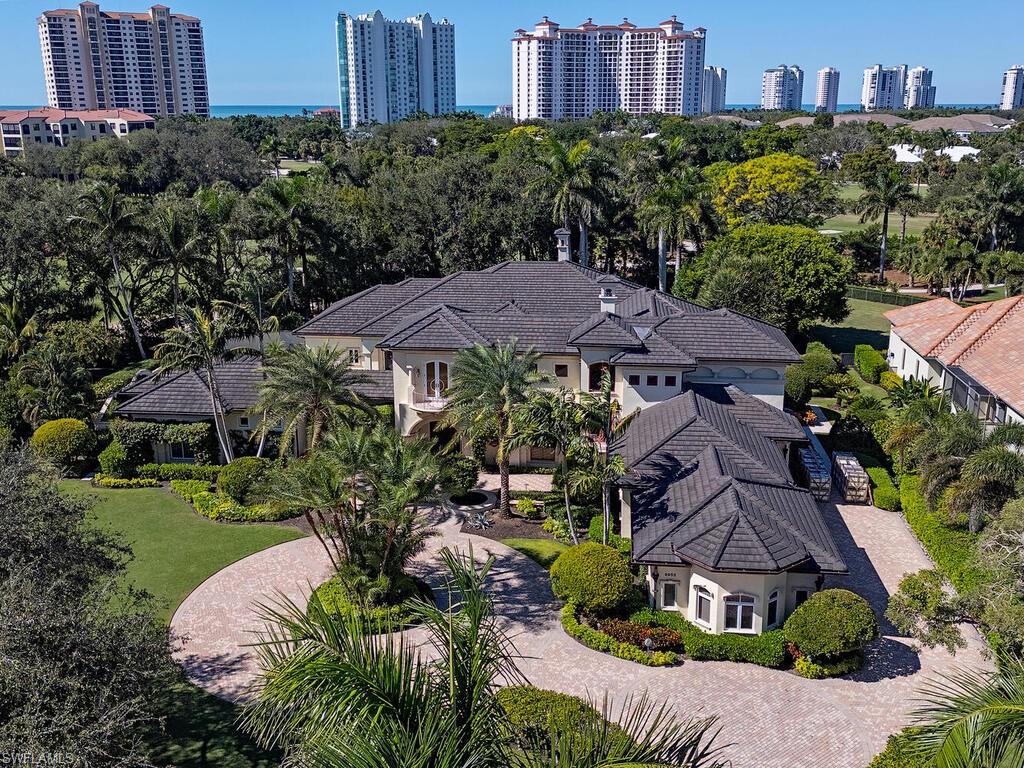 Set within one of Pelican Bay’s most exclusive gated enclaves, this remarkable estate occupies more than an acre along the golf course and delivers a level of privacy and resort-style living rarely found in the community. As one of only thirteen homes in this 24-hour manned neighborhood, the property offers tranquility while still being just moments from Pelican Bay’s private beach access.

The residence is designed around a dramatic central courtyard that creates the feel of a secluded resort. A magnificent 25-by-50-foot pool and elevated spa serve as the centerpiece, surrounded by both covered and open-air lounging and dining areas. An outdoor fireplace, a bocce court, a fire pit, and an outdoor pool table make the space ideal for everything from quiet evenings to large-scale entertaining. 

Inside, the home features six bedrooms, including four ensuite accommodations, along with an additional shared bath and two half baths. A separate guest cabana provides its own sense of retreat with a kitchenette and a breakfast space overlooking the pool—perfect for visitors or multigenerational living. The interiors include a richly finished wood-grained office, a dedicated theater, both family and formal living rooms, and a grand dining room that connects to a butler’s pantry. A separate wine and bar room enhances the home’s entertaining appeal, while two first-floor laundry areas and an oversized four-car garage add everyday convenience.