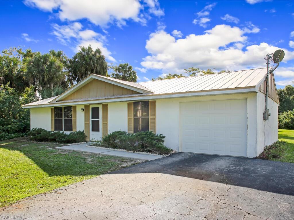 Welcome to your next home located just east of Collier Blvd. This home offers you 2-bedrooms, 2-bathrooms, 1-car garage, and 2.28 acres. It is the perfect starter home or Snowbird retreat. The home is located close to I-75 and has easy access to shopping, beaches.