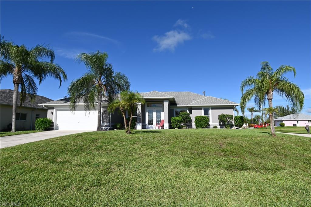 PRIDE OF OWNERSHIP! This beautiful and extremely well kept pool home in the deep Southwest of the Cape sits on an oversize corner lot in a fantastic and quiet neighborhood with quick access to Chiquita Blvd and Cape Coral Parkway. This beauty is sold turnkey except the car which can be purchased separately. The awesome furniture and decoration make this house so inviting and is perfect for a small family or could be used as a vacation home. Shutters were added in 2015, the pool cage was newly screened and the pool fence installed in 2016, new A/C and all duct work cleaned in 2017, new laminate in guest bedrooms, sealed garage floor and new washer in 2018, fresh paint outside and on curbings, bushes planted in back yard, sprinklers replaced, new gas grill, sprinklers connected to city irrigation line, faucets in master bath replaced and new kitchen disposal installed in 2019, front door painted, new tracks and rollers at all sliders and new water heater in 2020. Owner has taken special care of this home and you will love the privacy of the pool area with the view into the nicely landscaped backyard. Enjoy the SW Florida sunsets. This tastefully furnished home needs to be seen.